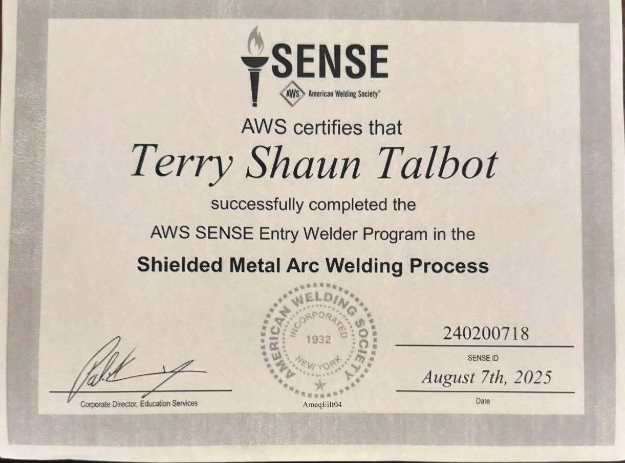 Certificate of completion awarded to Terry Shaun Talbot by the American Welding Society for successfully completing the AWS SENSE Entry Welder Program in Shielded Metal Arc Welding Process, dated August 7th, 2025.