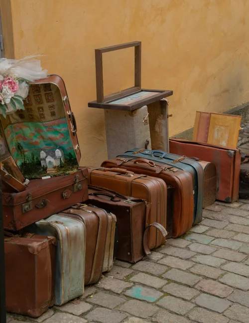 Vintage suitcases lined up on a cobbled street