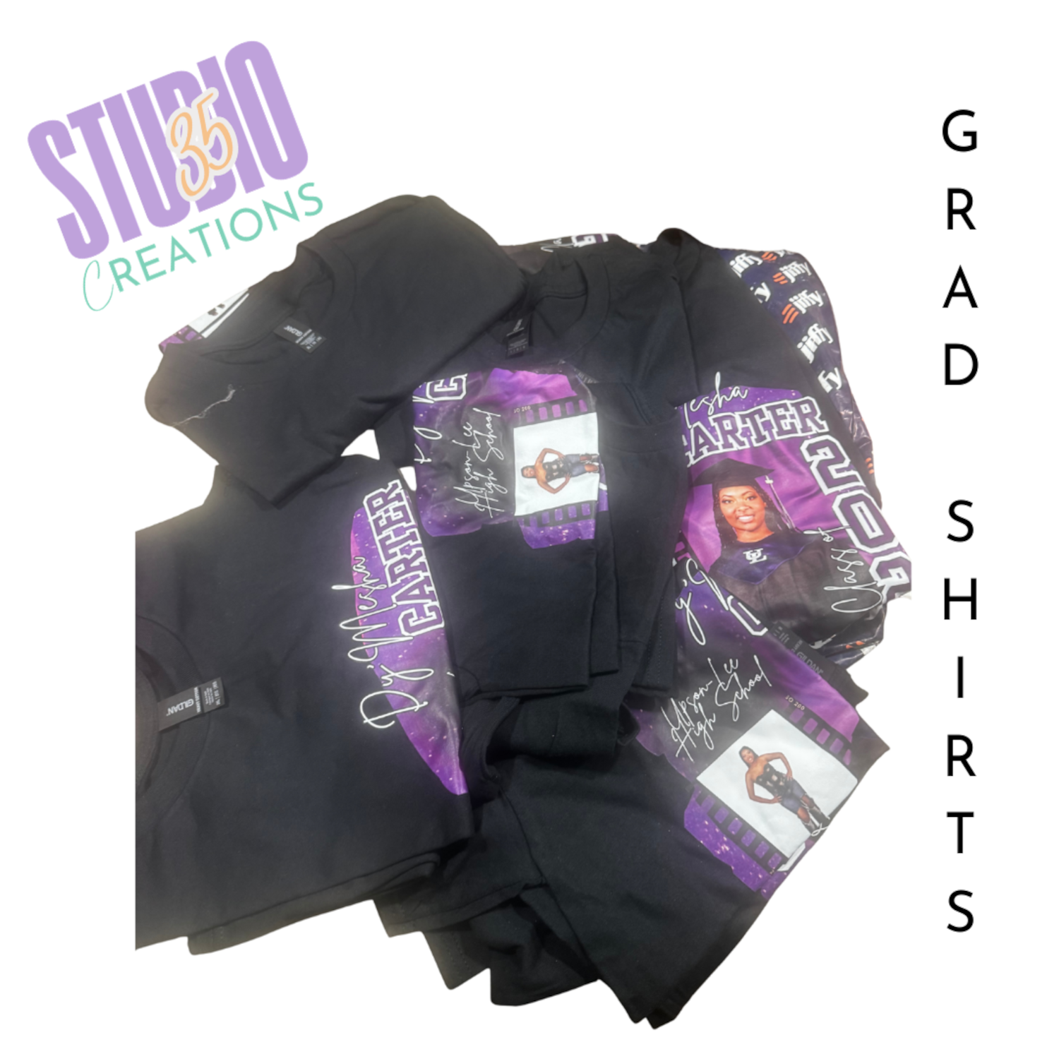 A collection of black T-shirts and fabric with purple and white graphics, including a graduate cap and woman in graduation gown, for a graduation celebration.
