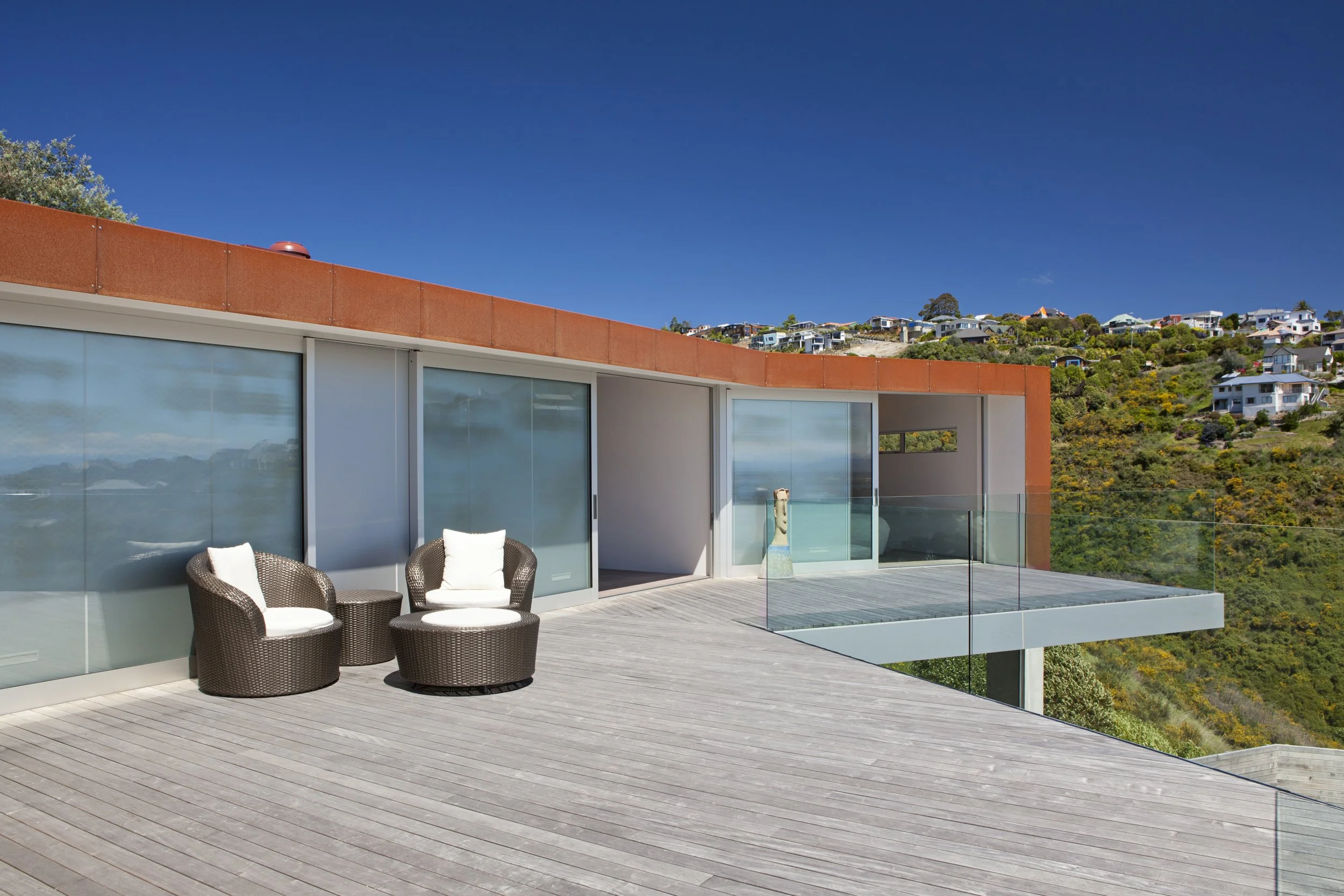 Redcliffs Cor-Ten House – Christchurch coastal home in weathered steel with expansive glazing by AW Architects (2012).