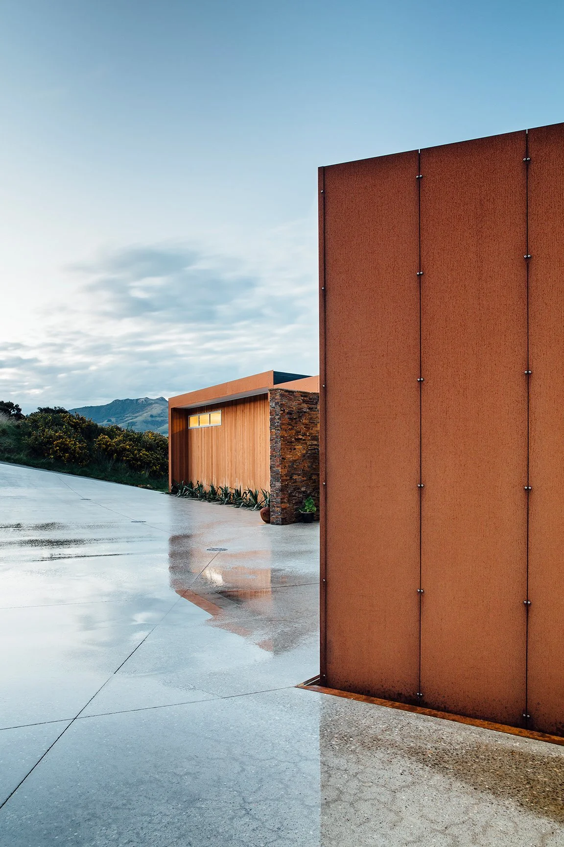 Akaroa Volcanic Ridge House – angular cedar and corten home overlooking Banks Peninsula by AW Architects (2014)