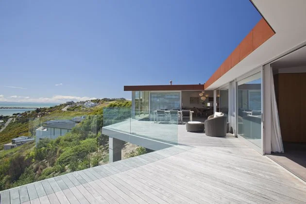 Redcliffs Cor-Ten House – Christchurch coastal home in weathered steel with expansive glazing by AW Architects (2012).