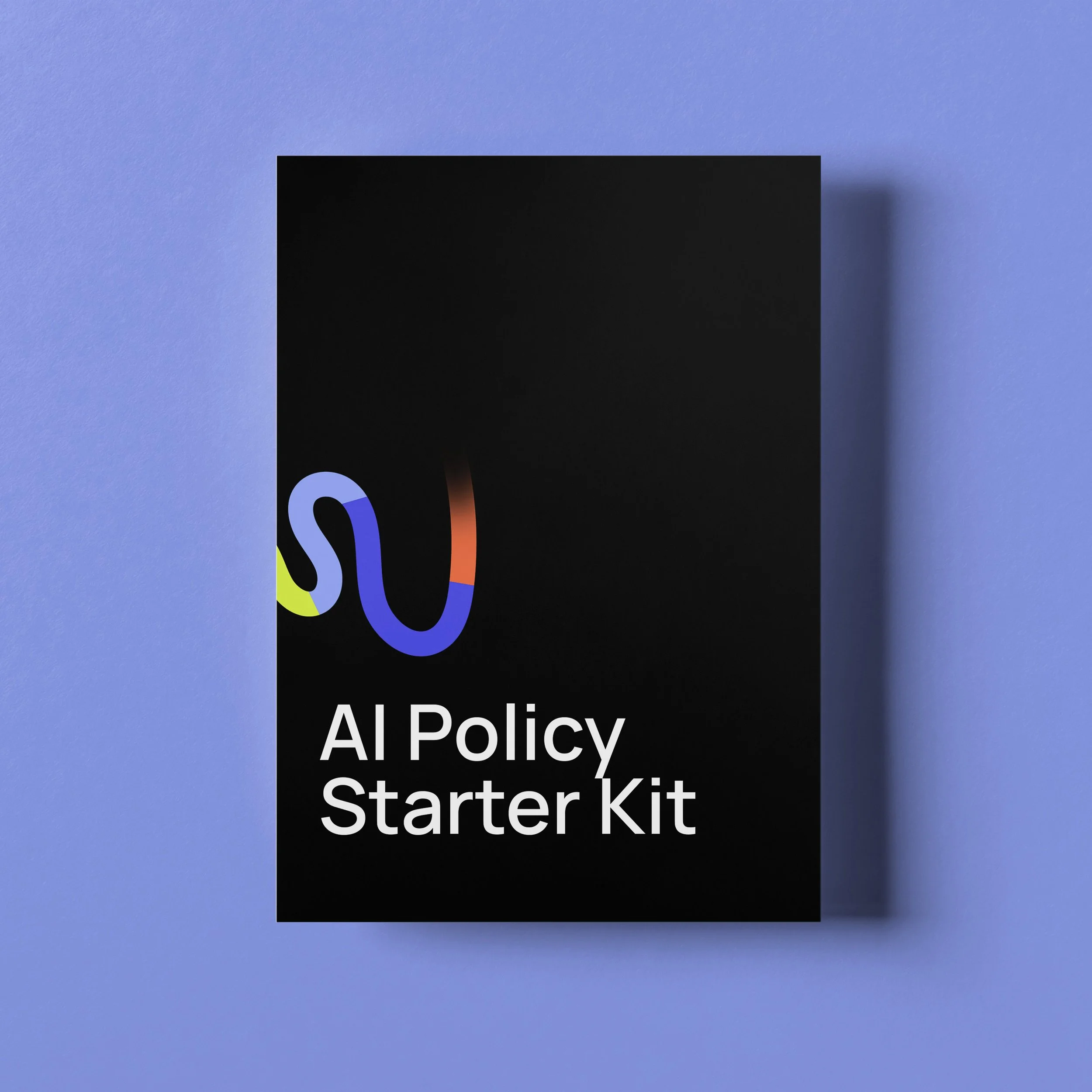 Black booklet titled 'AI Policy Starter Kit' with colorful abstract design on the cover, placed against a light blue surface.