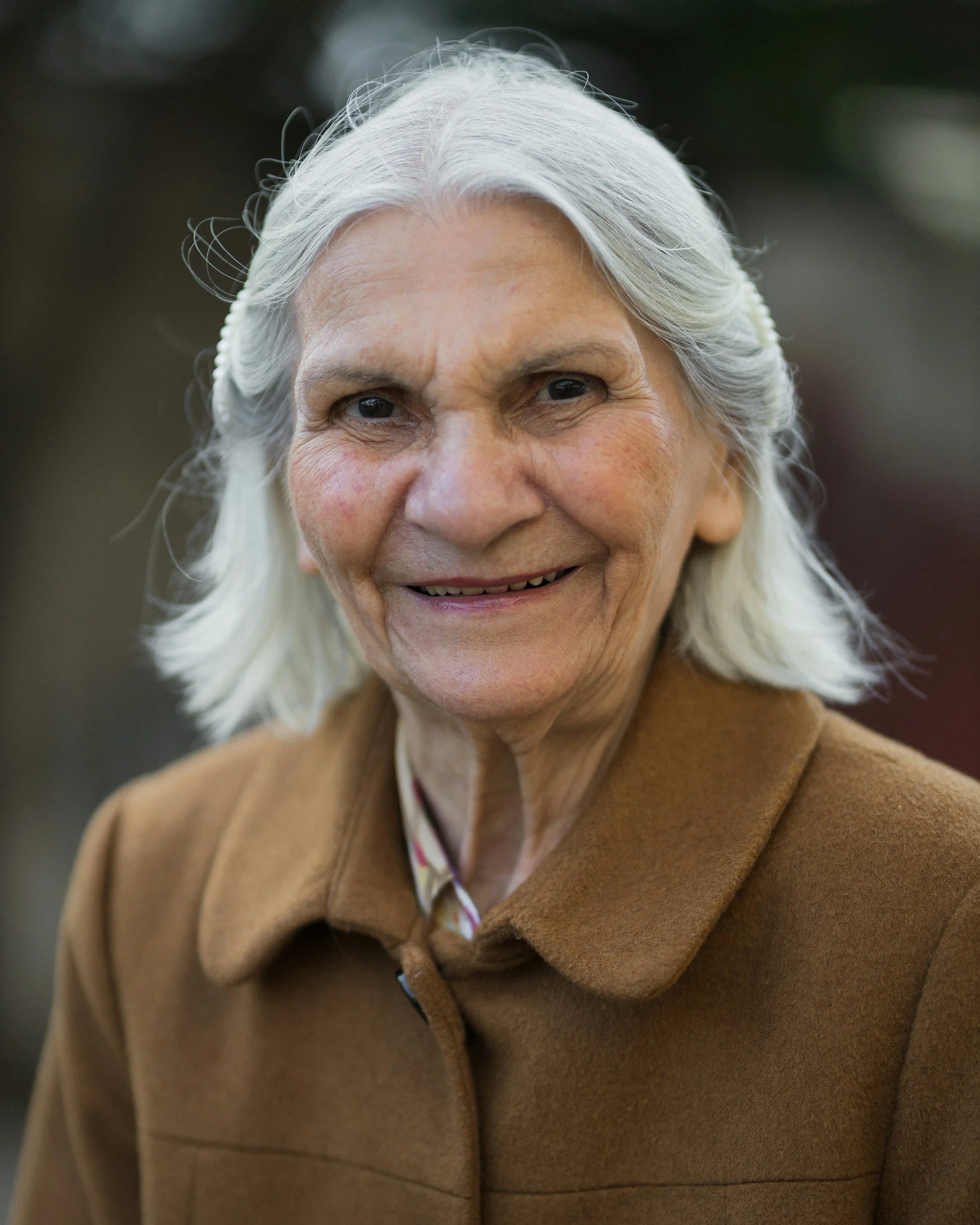 older woman in a brown coat
