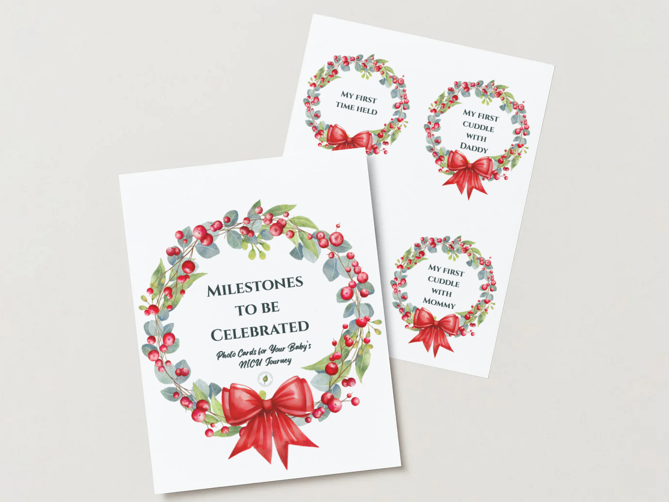 Three holiday-themed milestone celebration cards with wreath designs. One large card reads "Milestones to be Celebrated, Photo Cards for Your Baby's NICU Journey," featuring a red bow and green foliage with red berries. Two smaller cards have wreaths with red bows and text: one says "My First Time Held," and the other says "My First Cuddle with Daddy" and "My First Cuddle with Mommy."