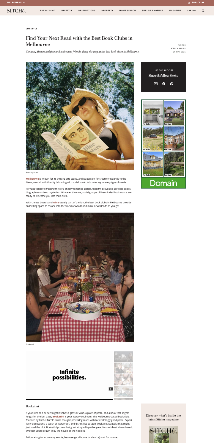 A woman with a straw hat and sunglasses reading a book outdoors with green trees in the background.