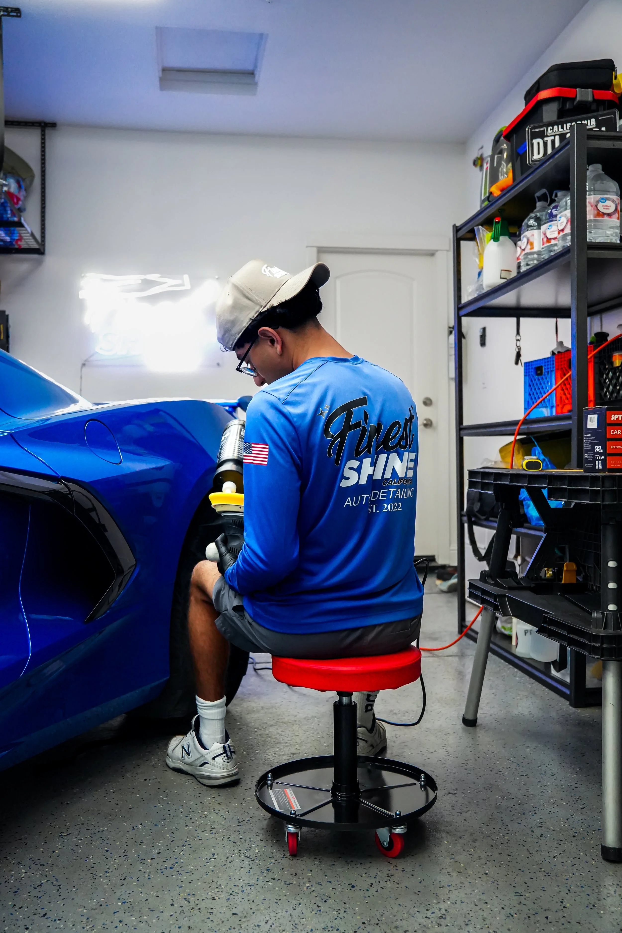 A person sitting down while putting polish on his polishing pad