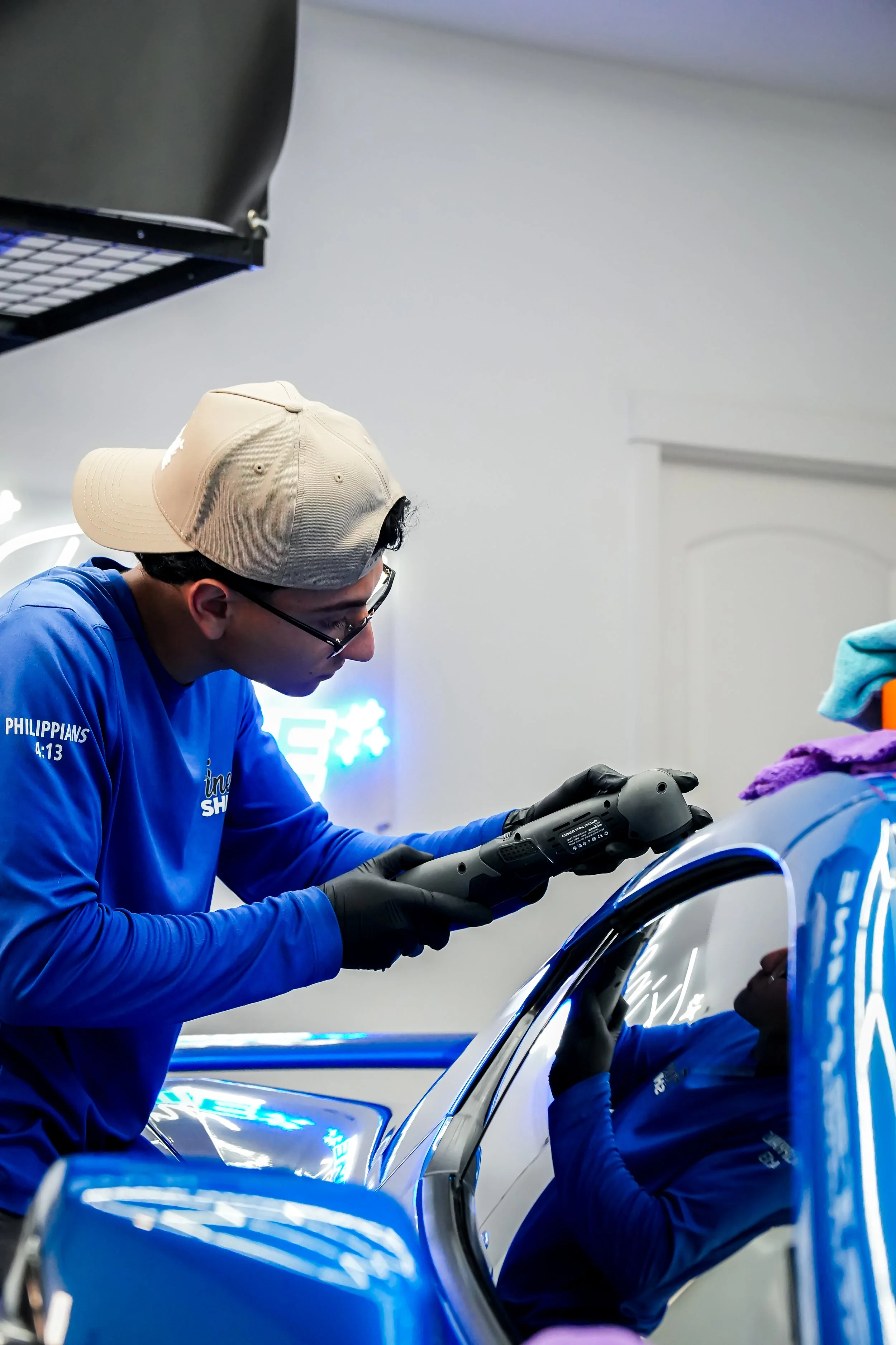 A person buffing a car
