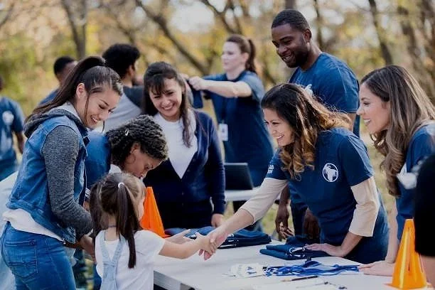 Empowered Smiles Initiative volunteers packing toothbrushes into dental hygiene kits