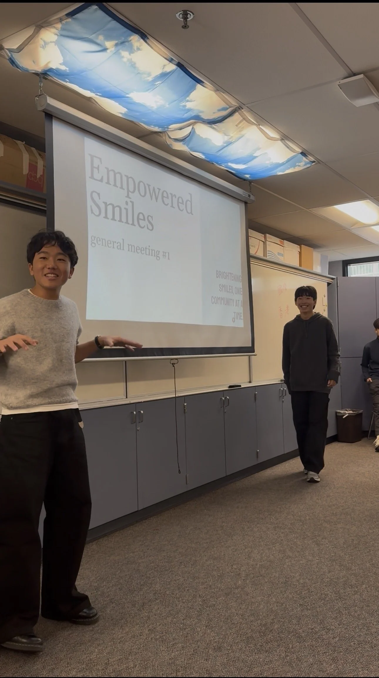 ESI co-founders Peter Lee and Kenneth Jin giving an educational seminar to their school community in front of a large audience of youth.