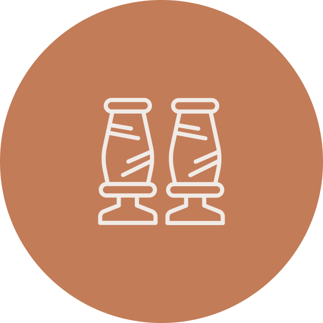 Line drawing of two salt shakers on a brown circular background.