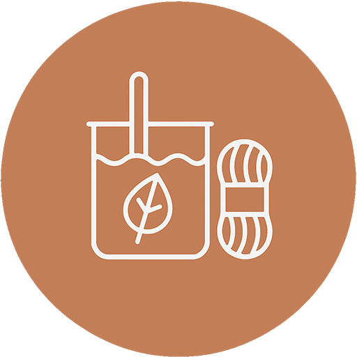 A leaf tea bag and a ball of yarn yarn on a brown background.