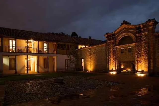 A historic building with illuminated entrance and windows at night.