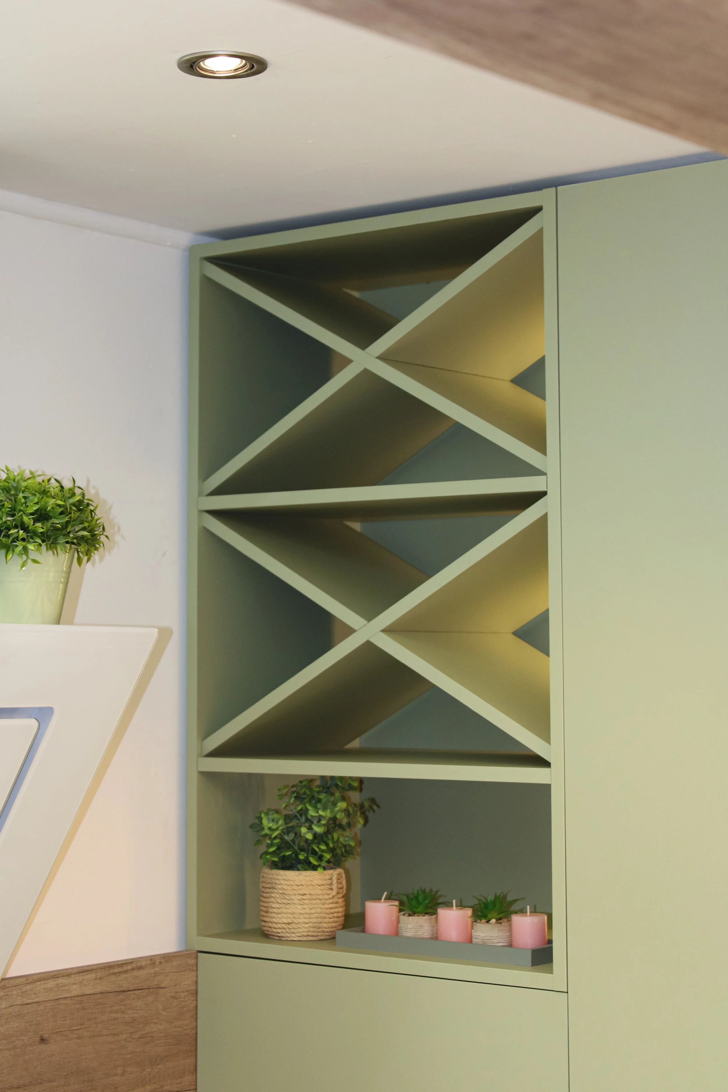 “Custom kitchen wine rack with matte green finish and integrated LED lighting, detail design by Bespoke Interijeri.