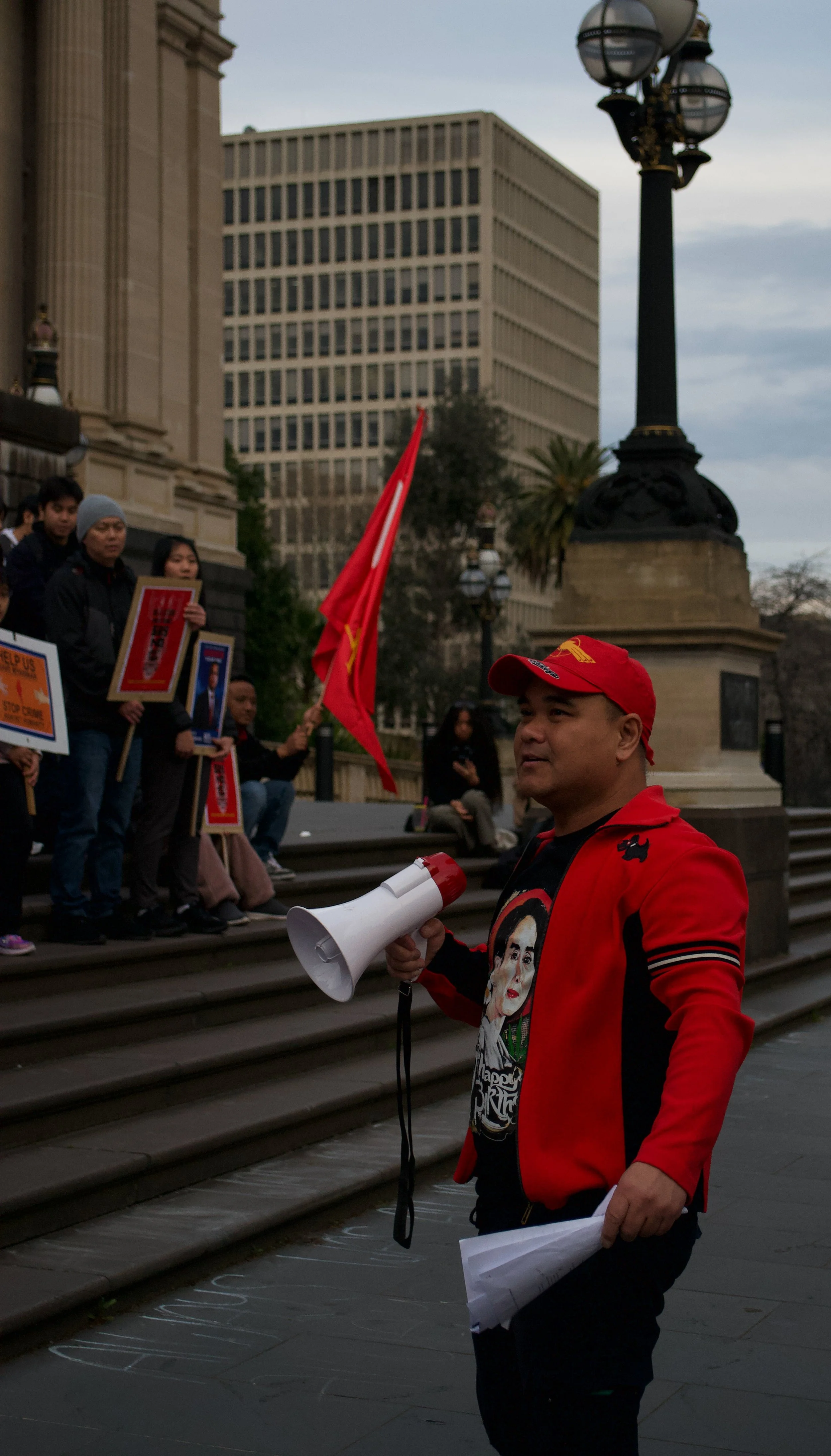 A protest speaker looks toward the crowd after starting a chant 06.09.2025