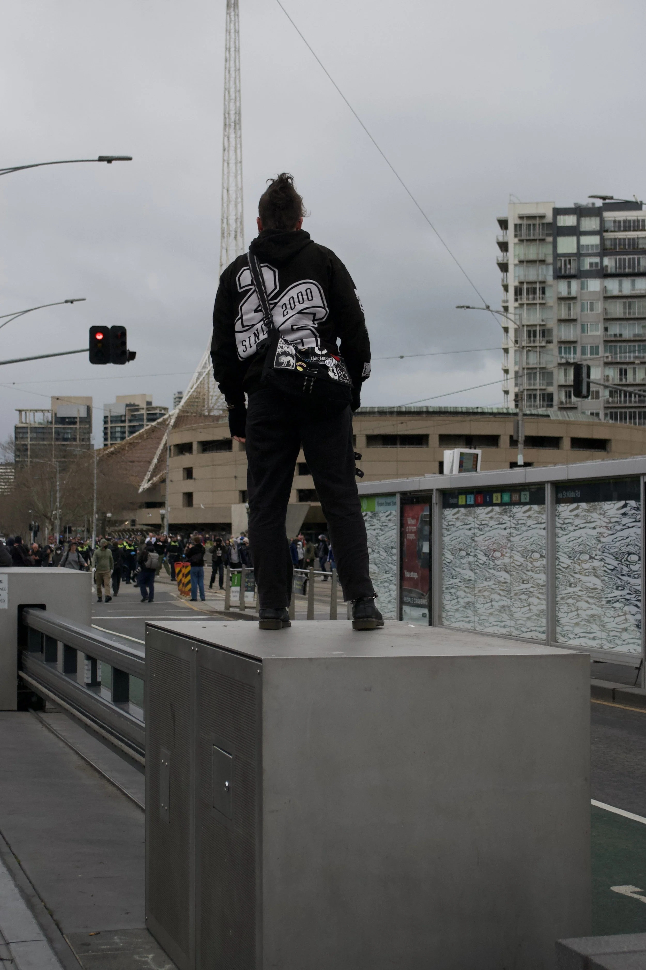 A counter protester stares down Victoria Police and the 'March for Australia' protesters at Fed Square.