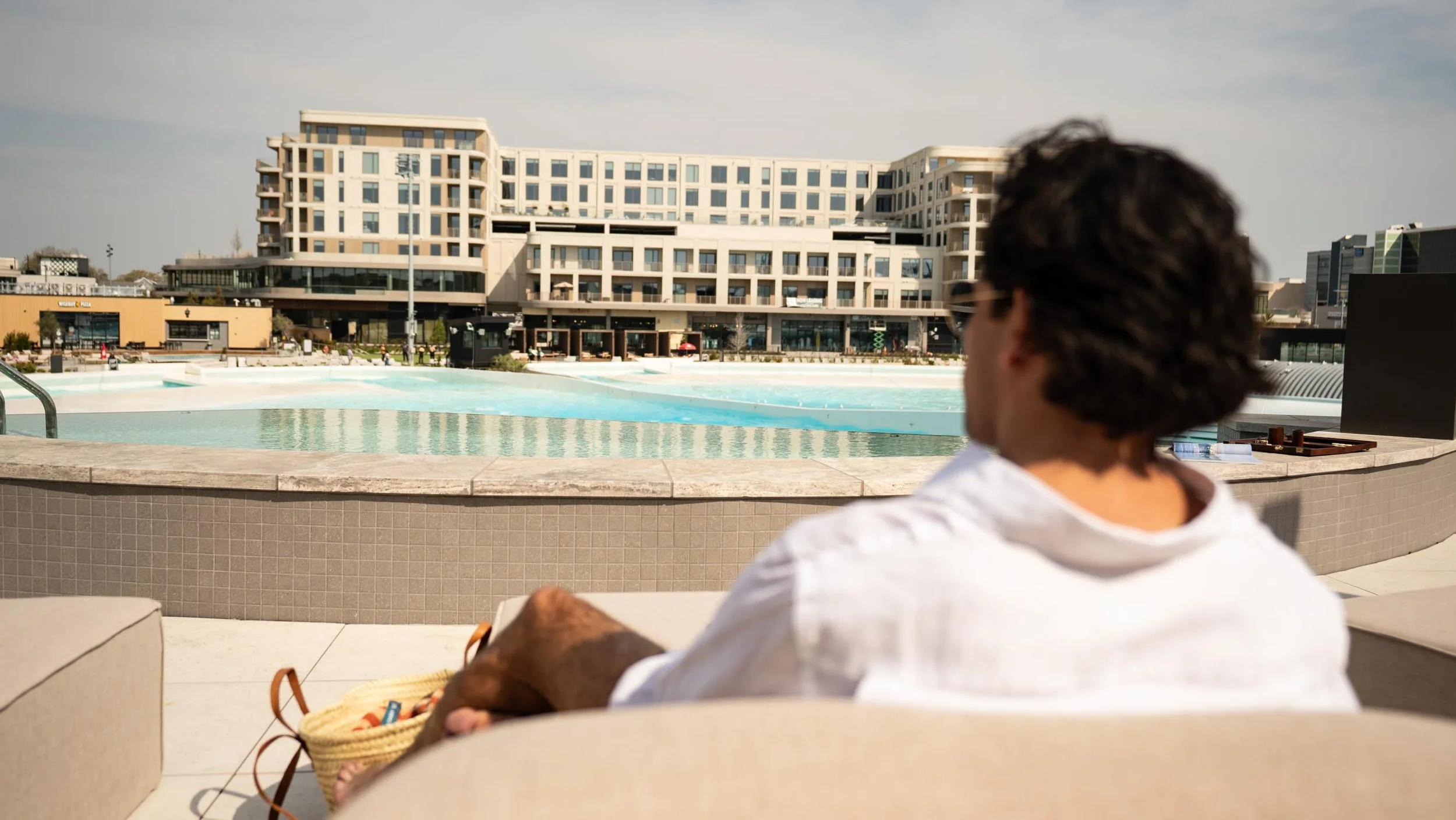 Sitio guests relaxing poolside at a surf hotel in Virginia Beach