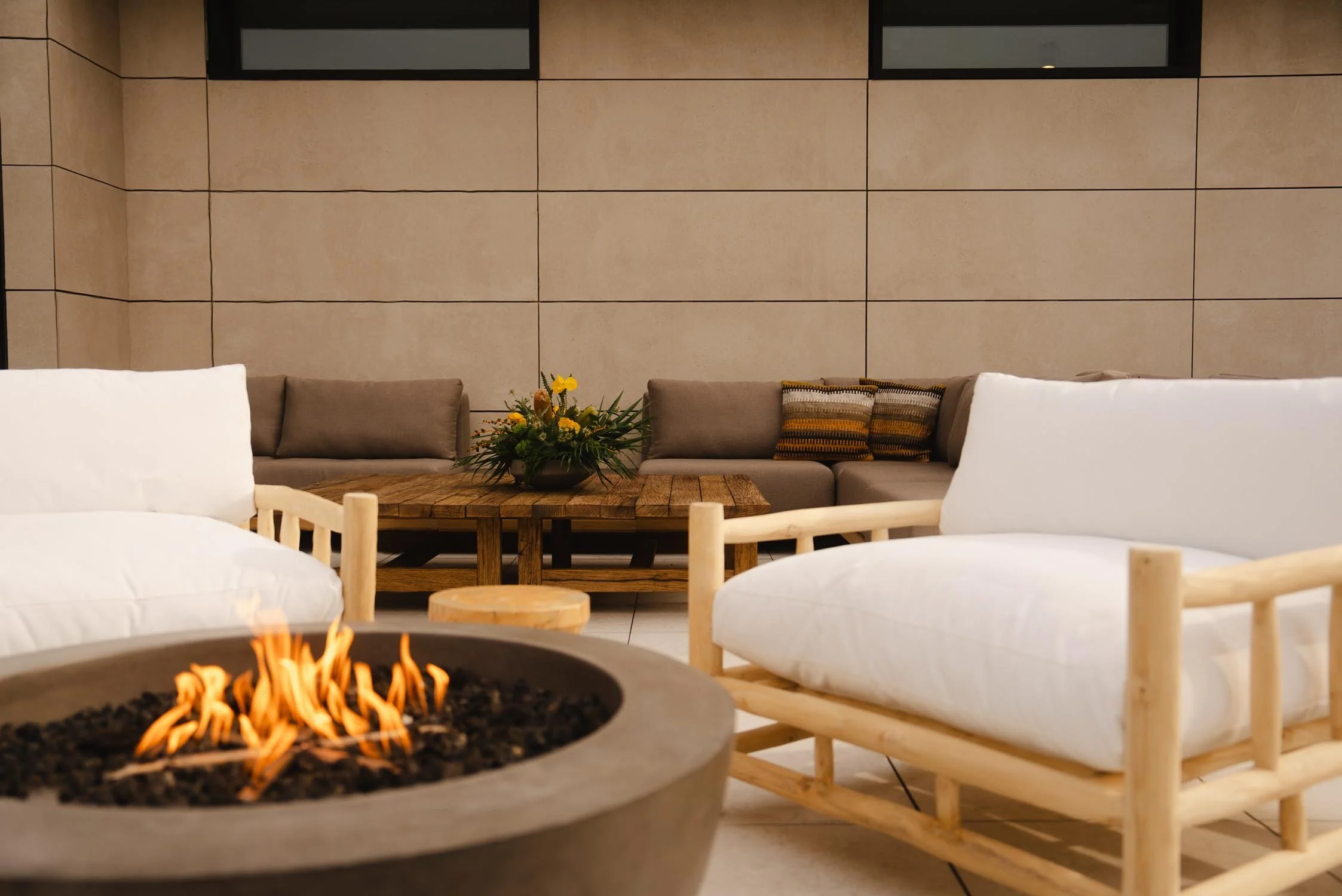 Two chairs by the firepit outside The Sitio at Atlantic Park in Virginia Beach