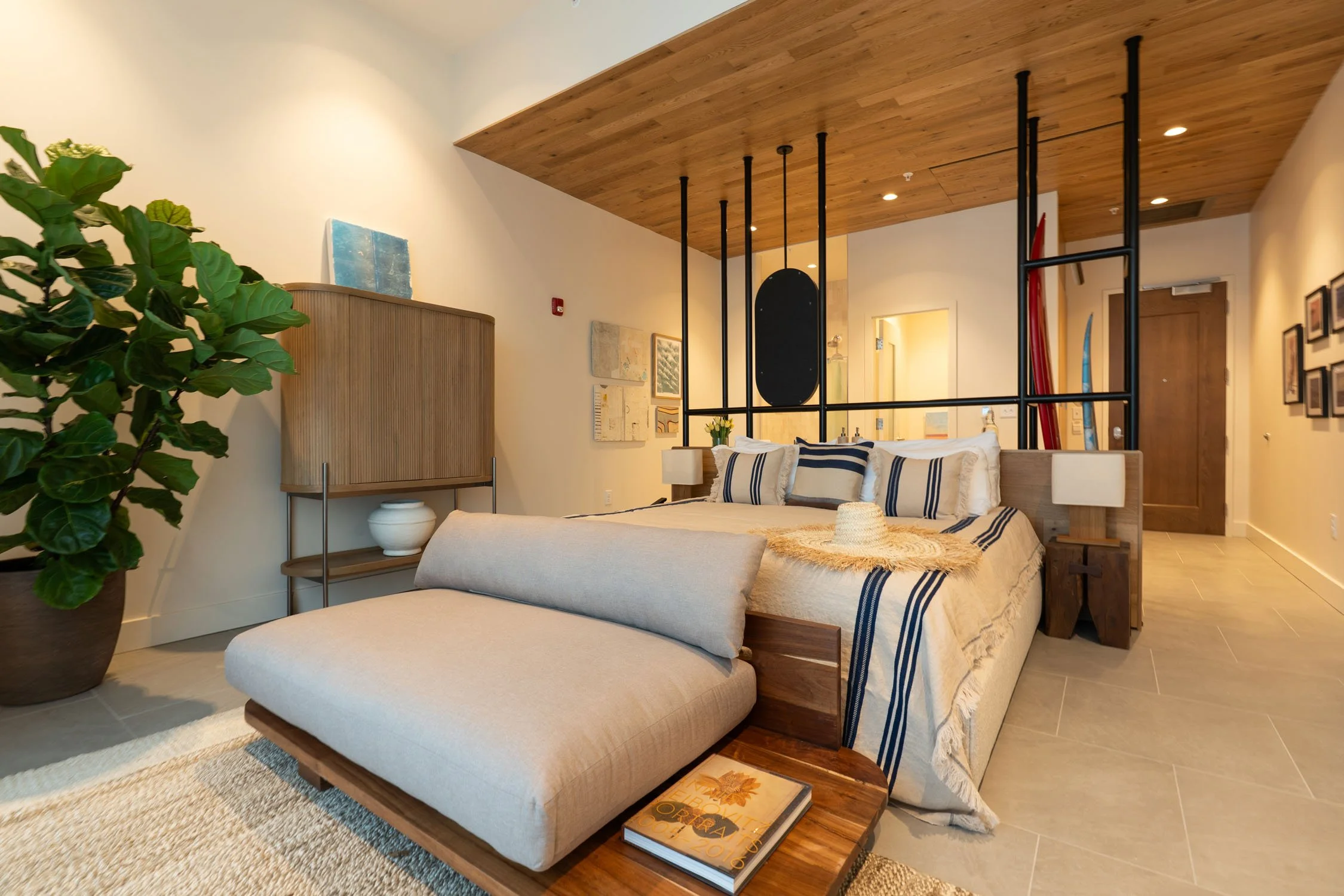 King room at hotel near Virginia Beach surf park overlooking the surf lagoon with a custom king bed and surfboard racks