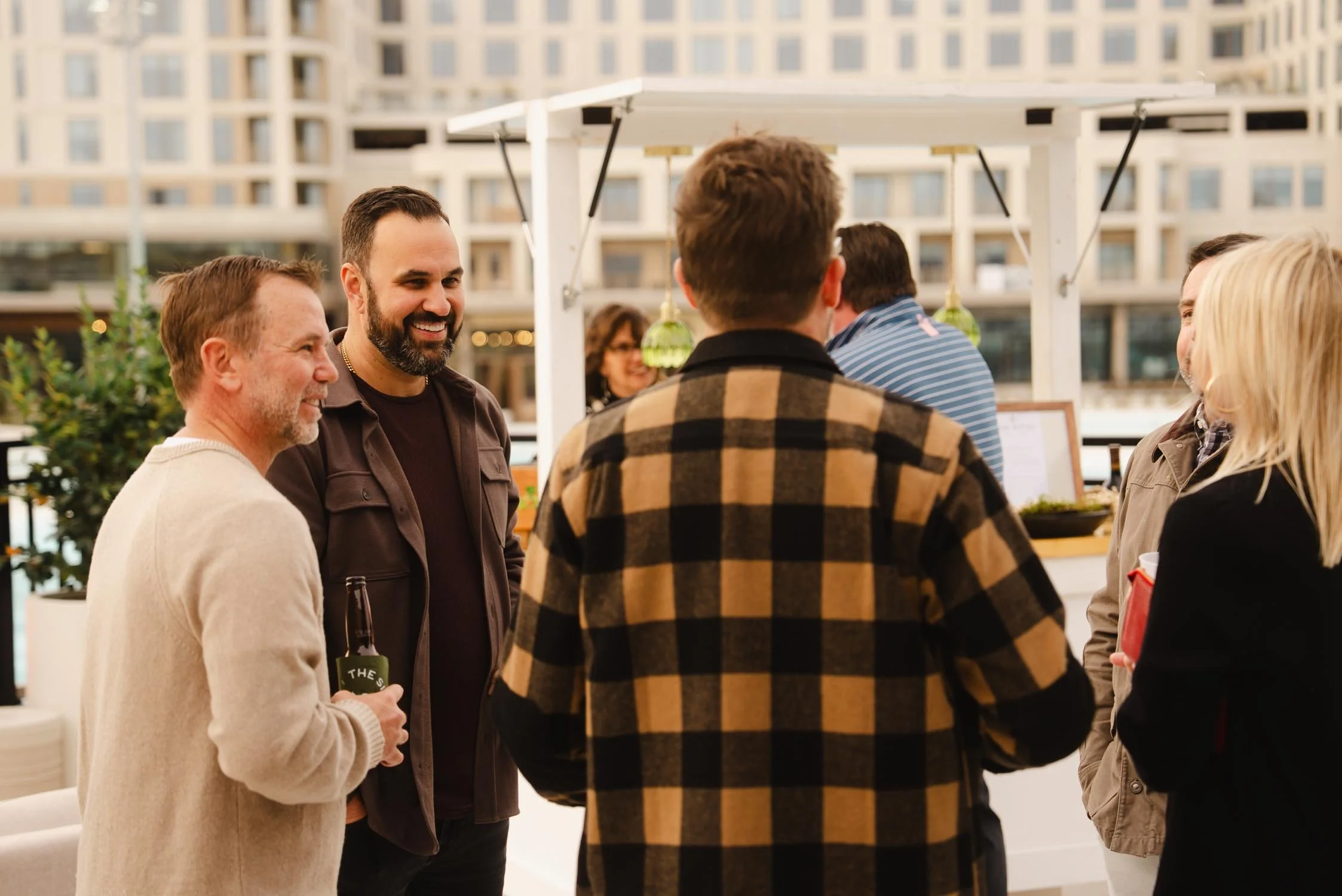 Guests mingling on the pool deck at The Sitio during a milestone celebration in Virginia Beach