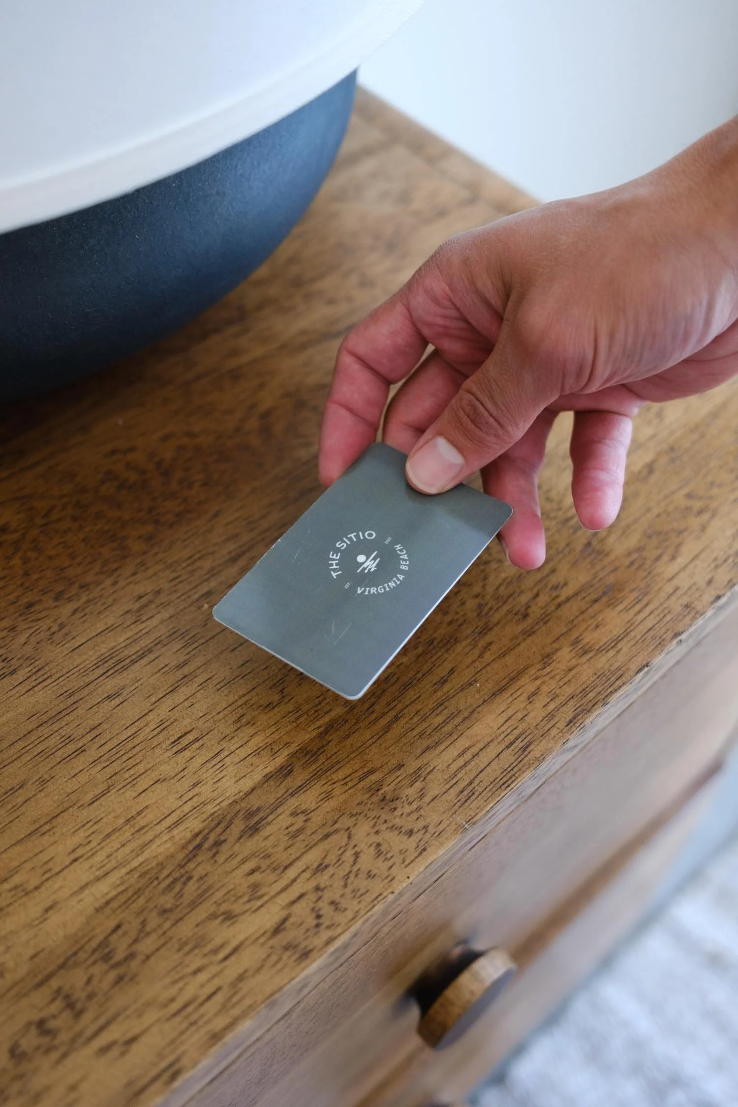 Hand holding a The Sitio key card at boutique hotel in Virginia Beach