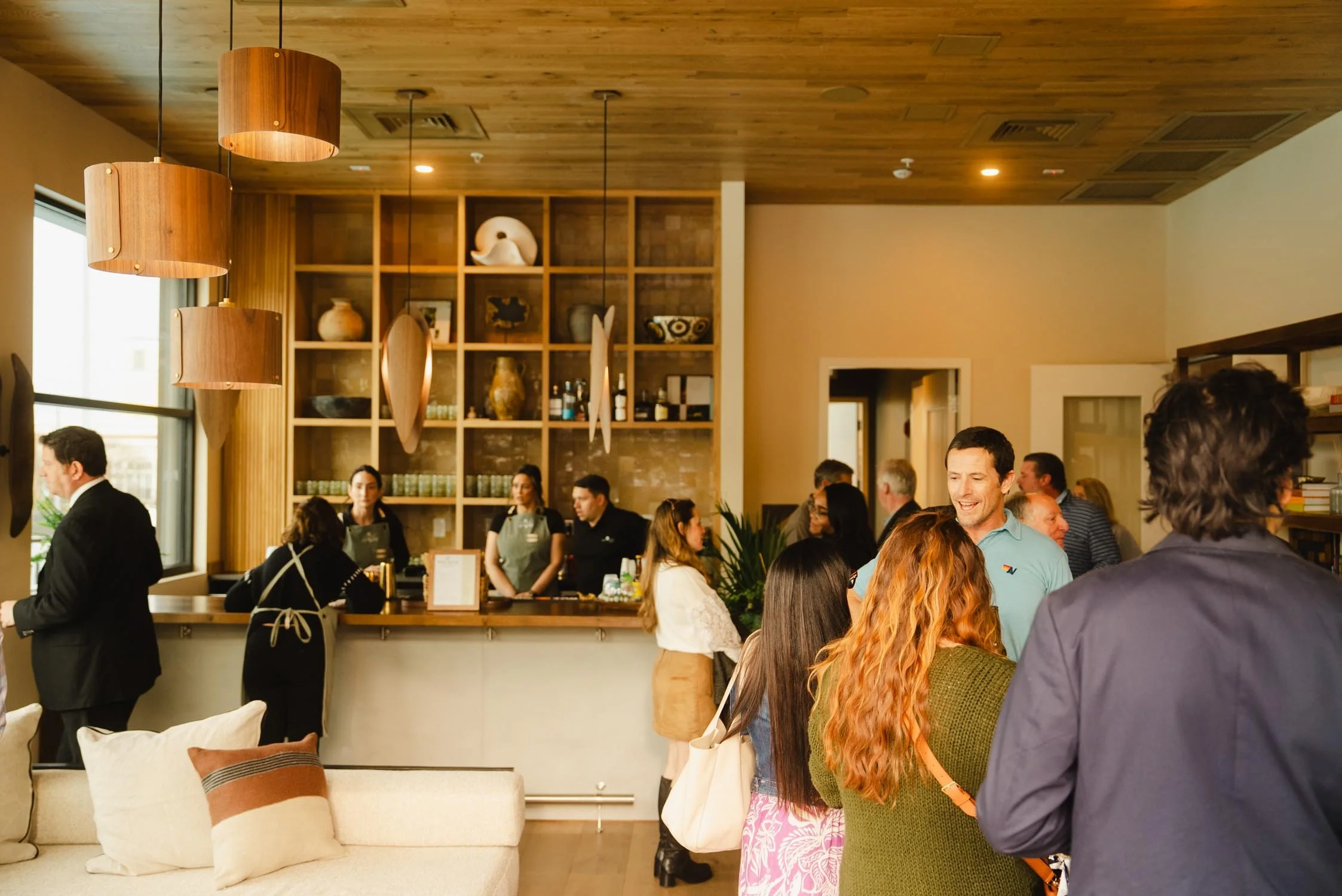Guests gathered in The Sitio hotel lobby during a branded social event at a boutique hotel in Virginia Beach
