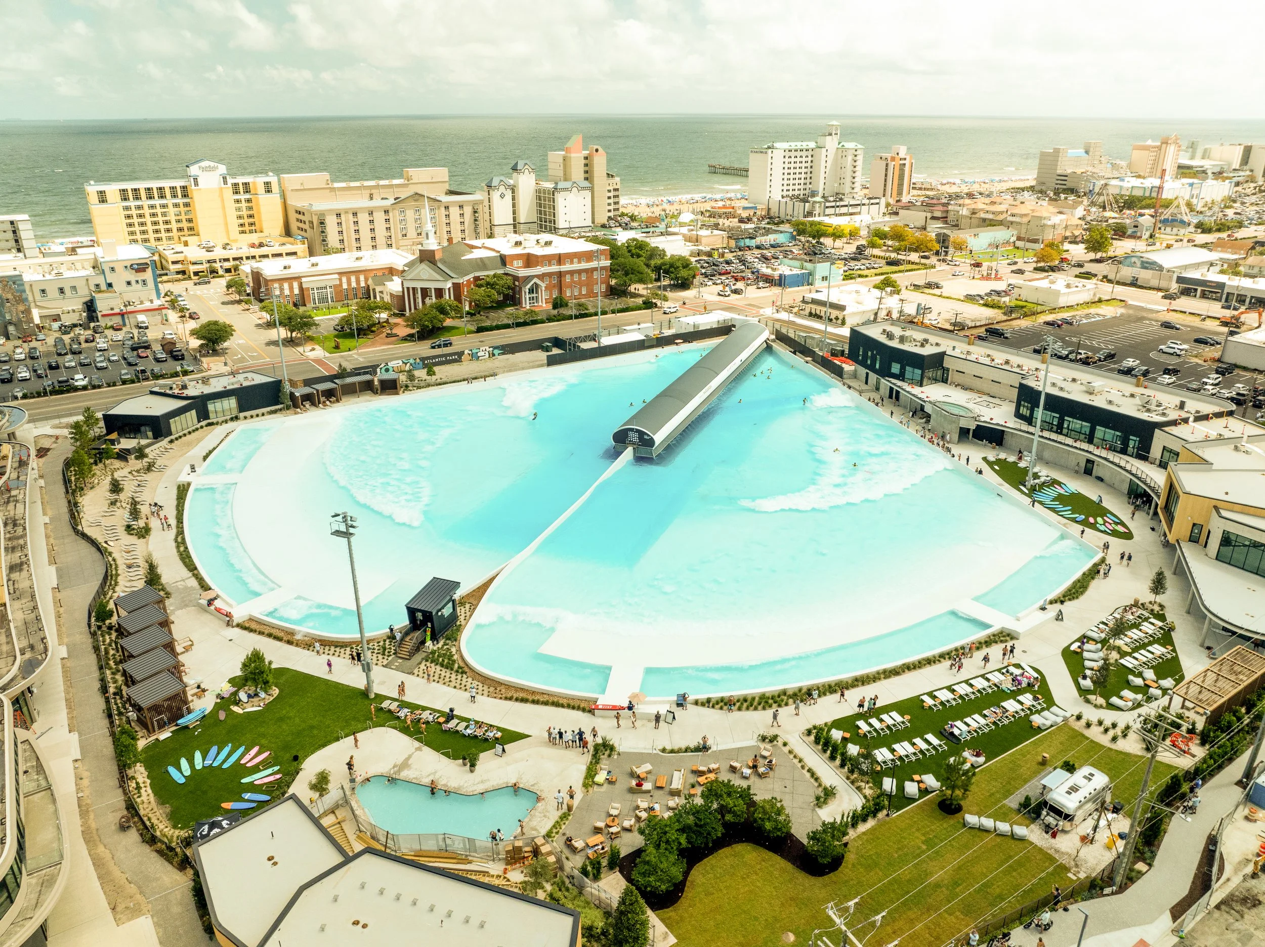 Aerial view of surf park and ocean in the distance at hotel near Atlantic Park