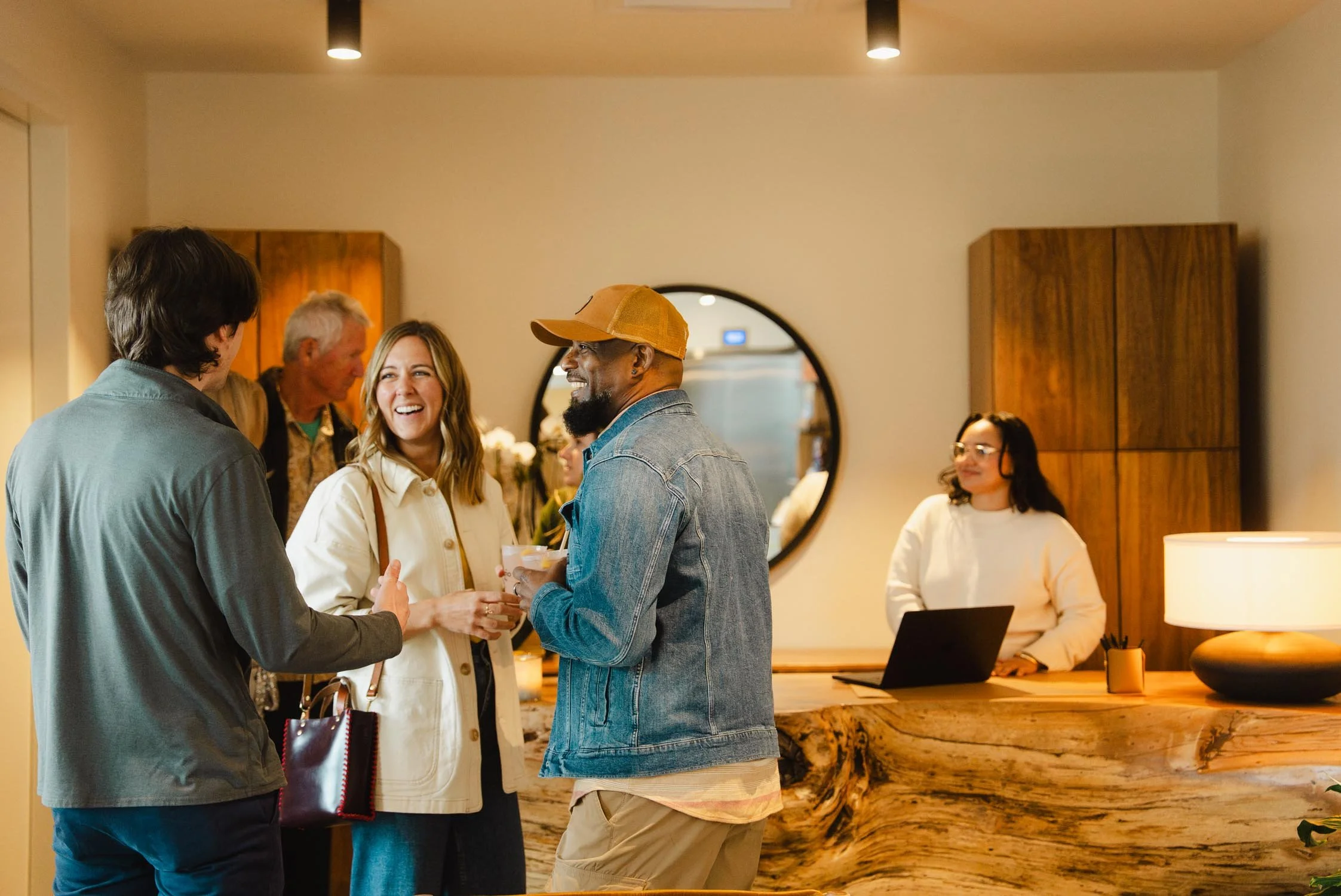 Guests mingling at the check-in desk at The Sitio, a boutique hotel in Virginia Beach