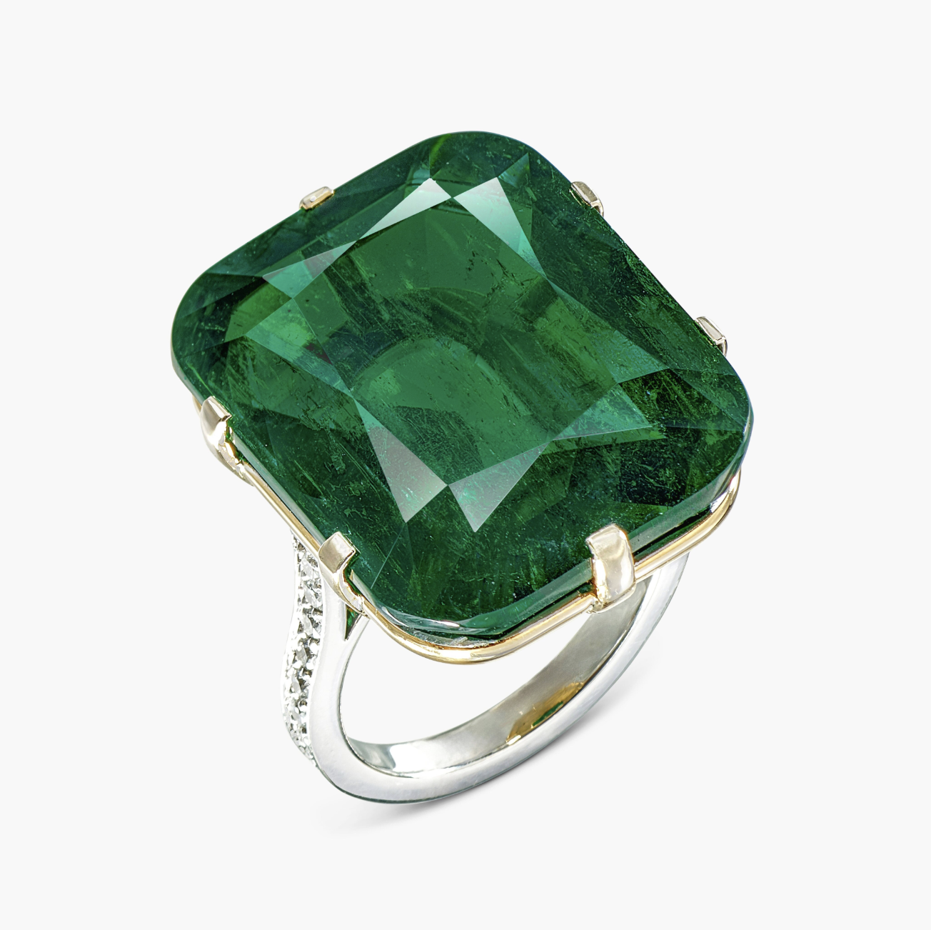 Close-up of a 32-carat emerald and diamond ring sold at Sotheby’s High Jewellery auction, featuring a vivid green step-cut emerald set in a refined platinum mount