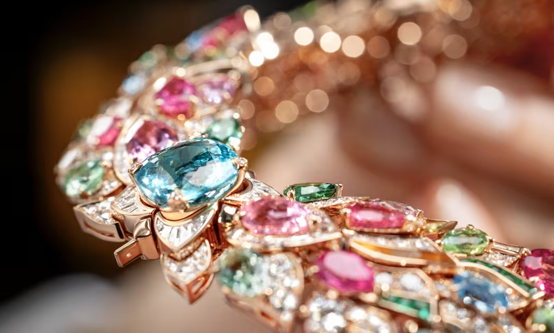 Close up of the Bvlgari Celestial Mosaic Necklace featuring a 131.21 carat Tajik spinel centre stone, surrounded by multi coloured tourmalines, emeralds, turquoise, onyx and pavé diamonds in rose gold.