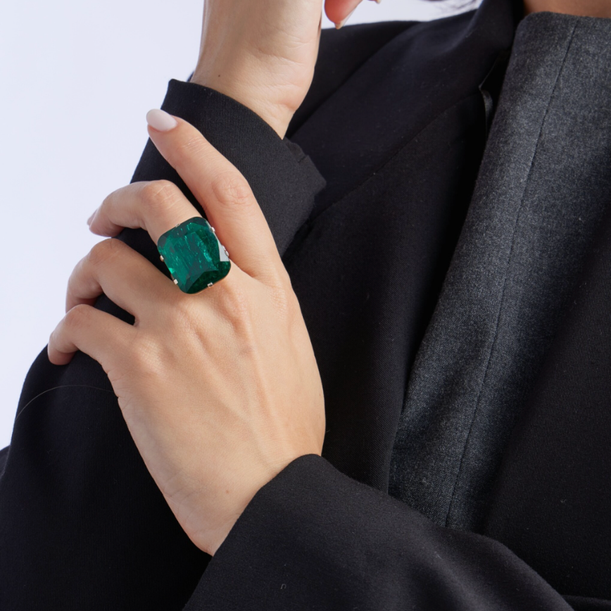 High jewellery emerald ring featuring an approximately 32-carat emerald surrounded by diamonds, presented as part of a Sotheby’s auction lot