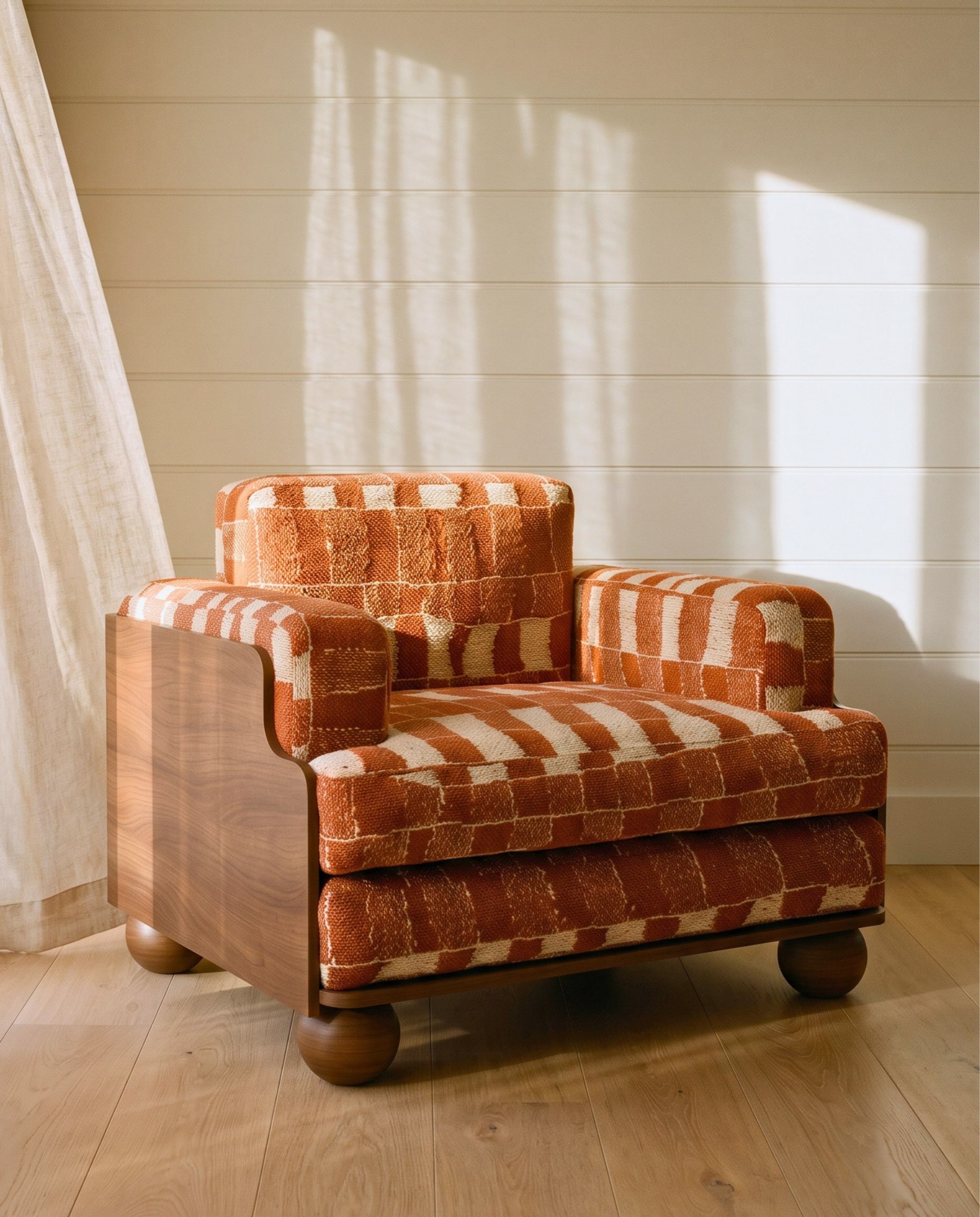 A first look at the new Cove XL Armchair.

A familiar form, reimagined on a more generous scale. A taller back, wider seat and layered cushioning create a deeply comfortable, higher seat.

Shown here in red Promenade with a solid chocolate oak frame,