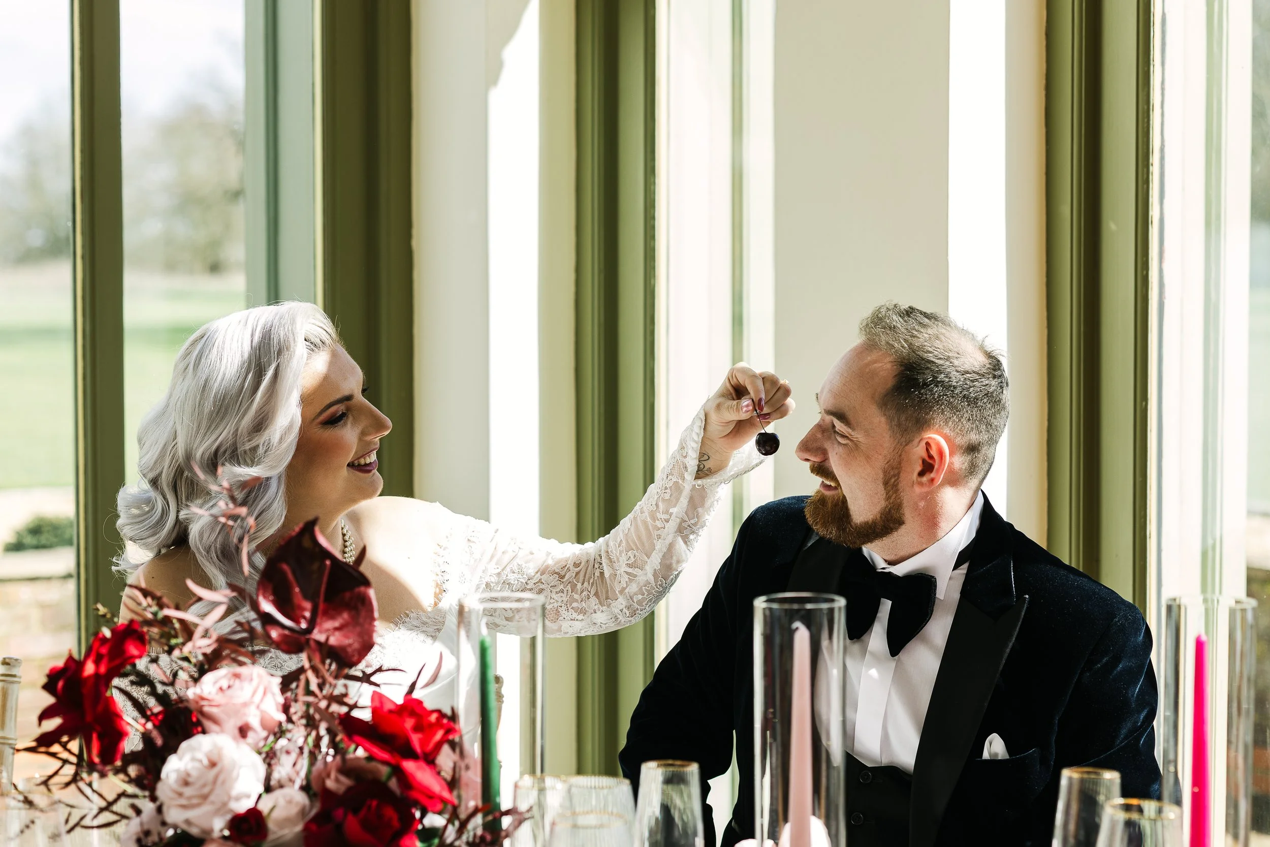 Bride feeding her groom cherries at Offley place hertfordshire