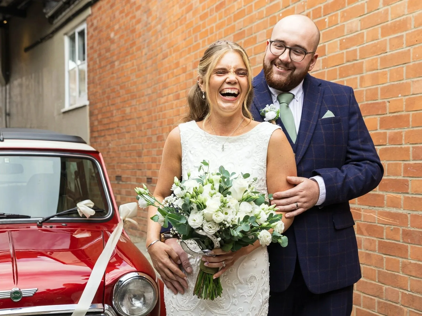 Bride and Groom laughing on their wedding day in Bedfordshire