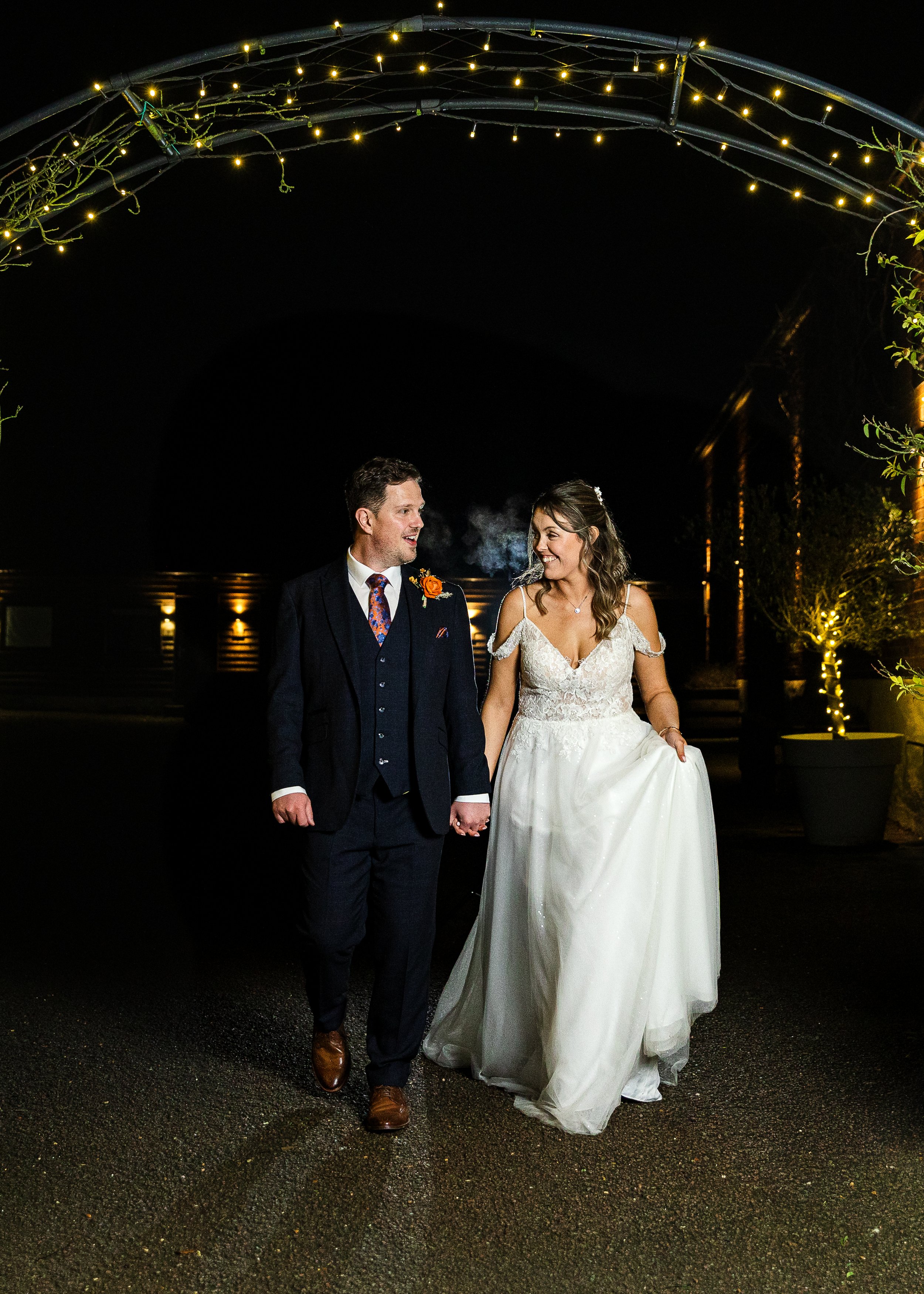 Bride and groom under Christmas lights at their Hertfordshire wedding 