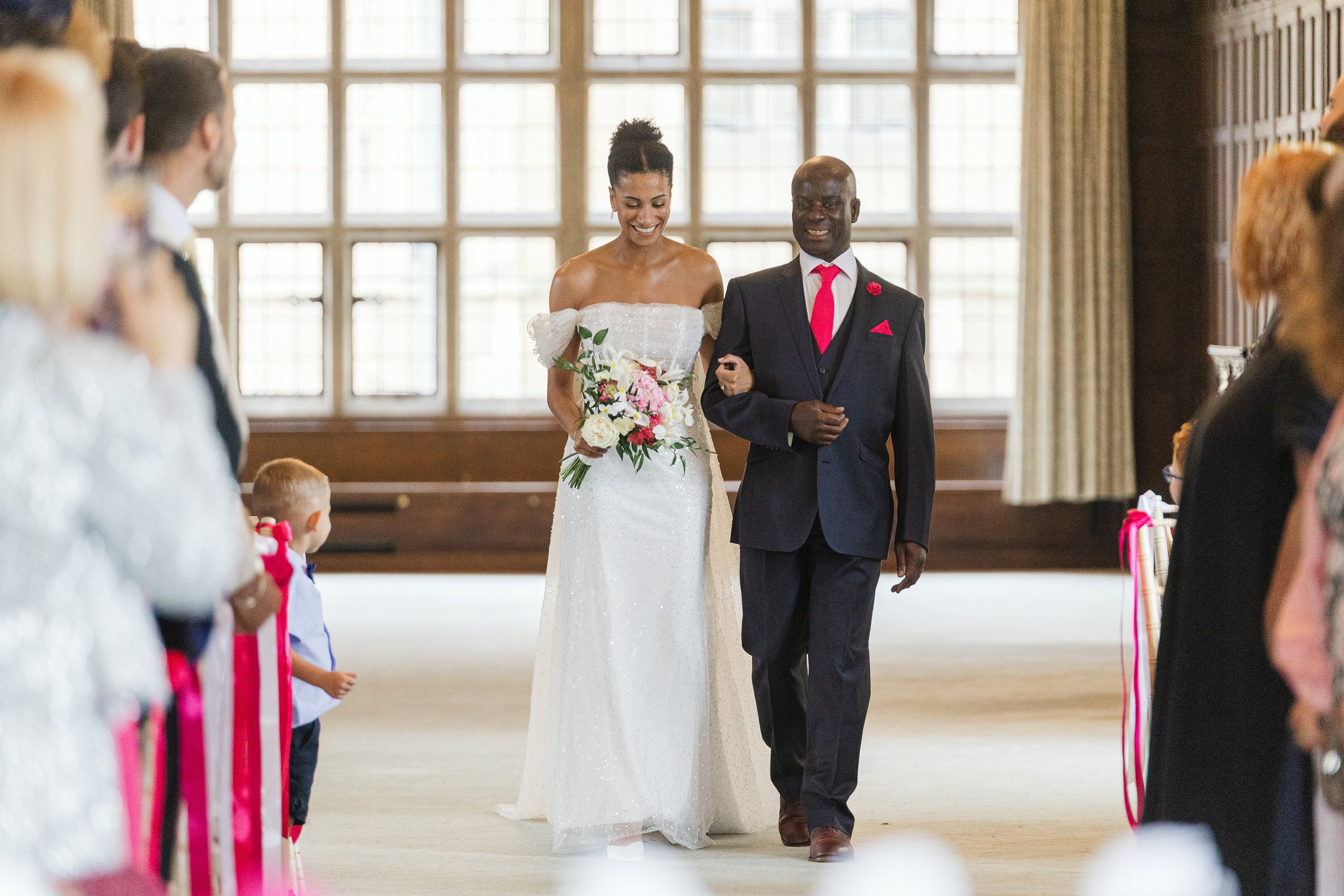 Bride being walked down the aisle by the father of the bride