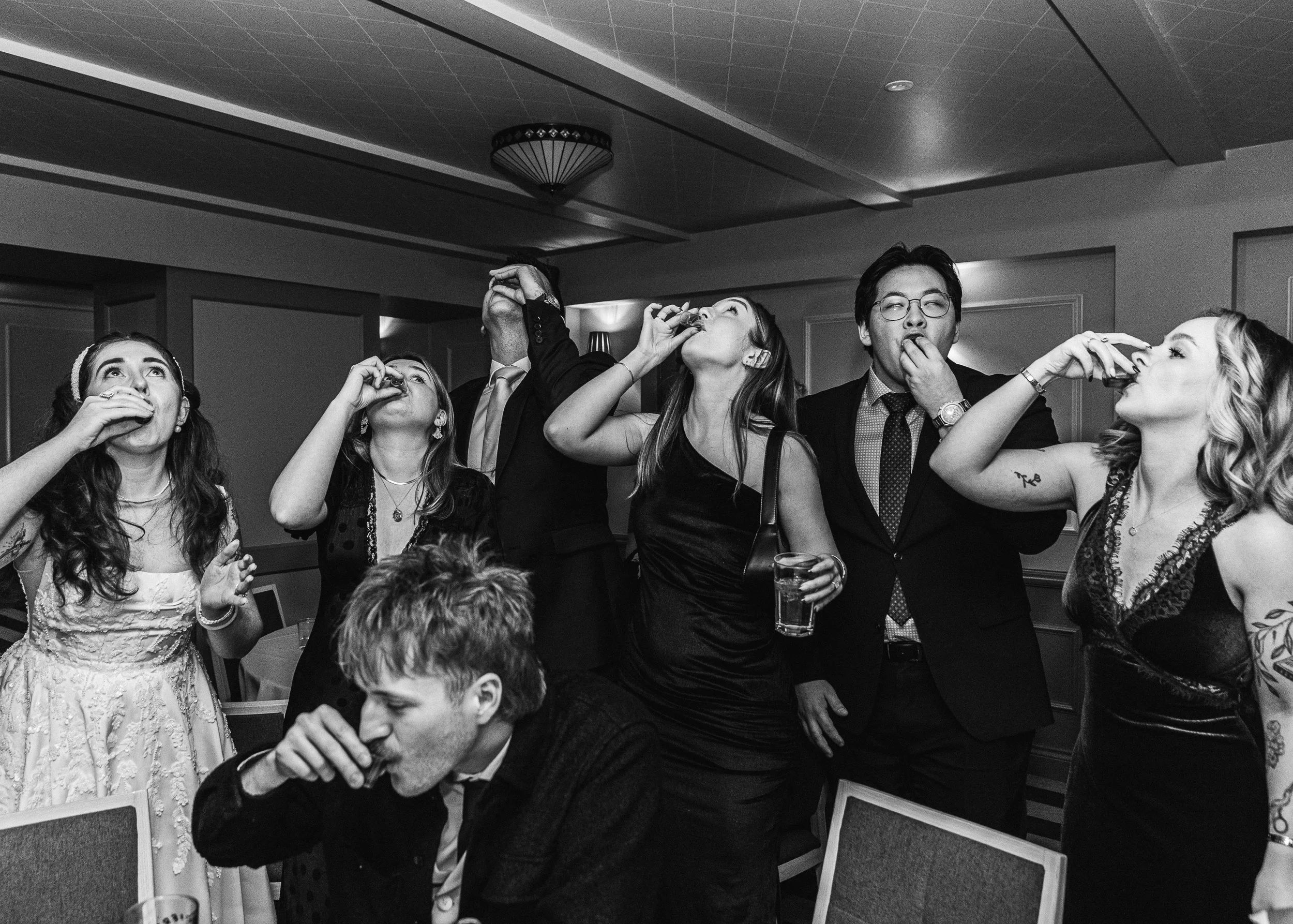 Wedding party drinking shots with the bride at her Hertfordshire wedding 