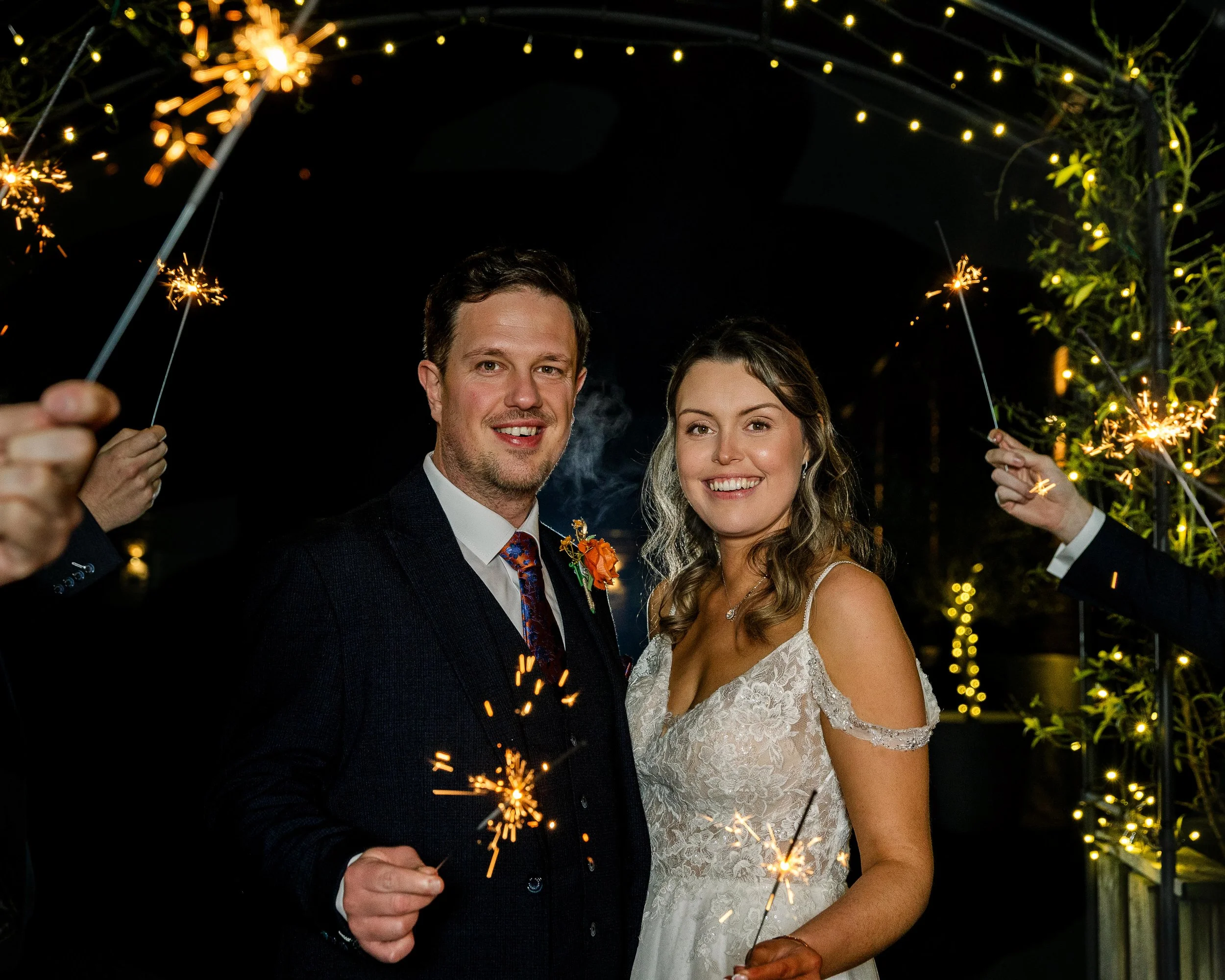 Bride and Groom holding sparklers during their Christmas wedding in hertfordshire