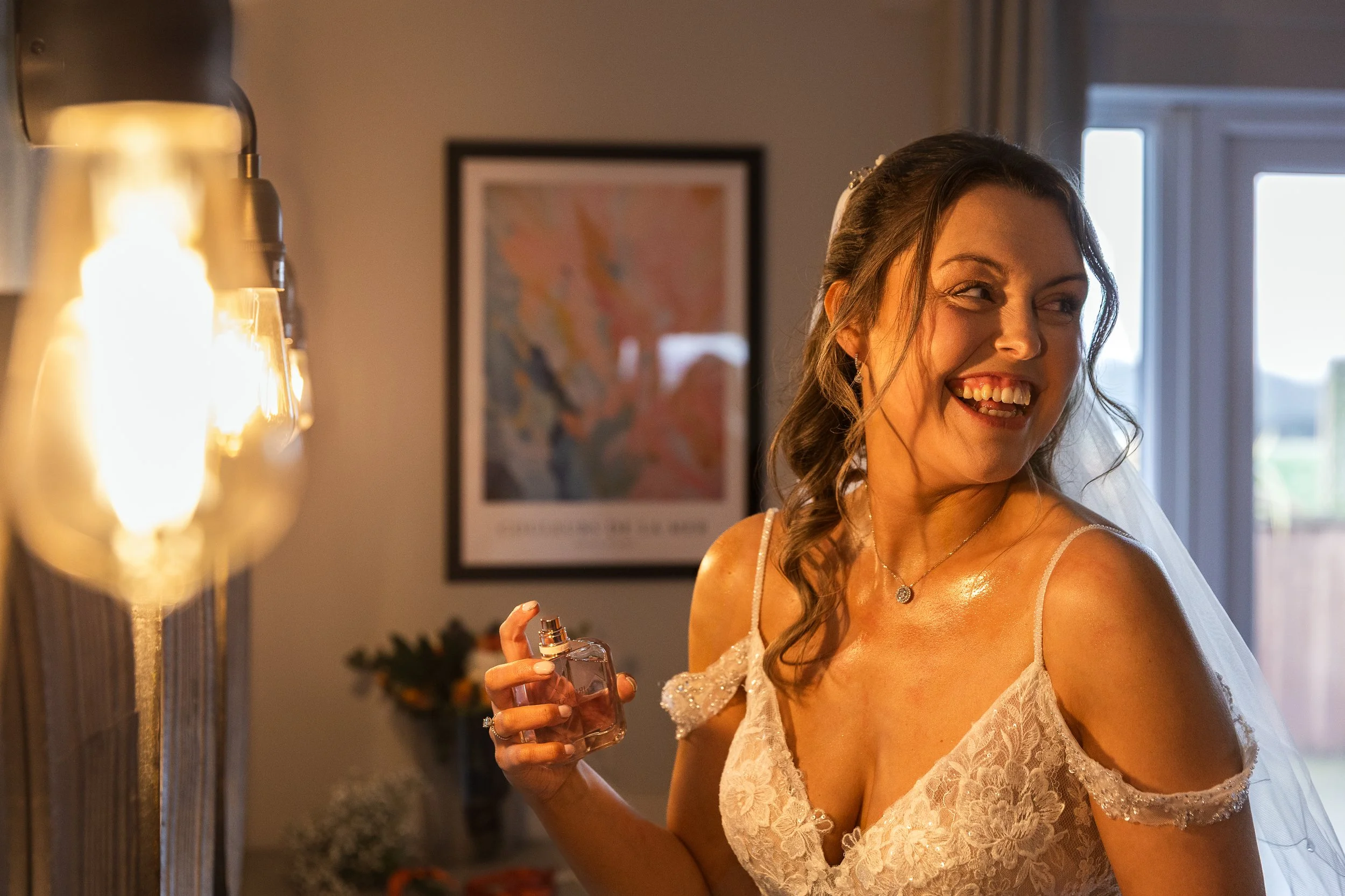 Bride spraying perfume on her wedding day at a Hertfordshire Wedding venue