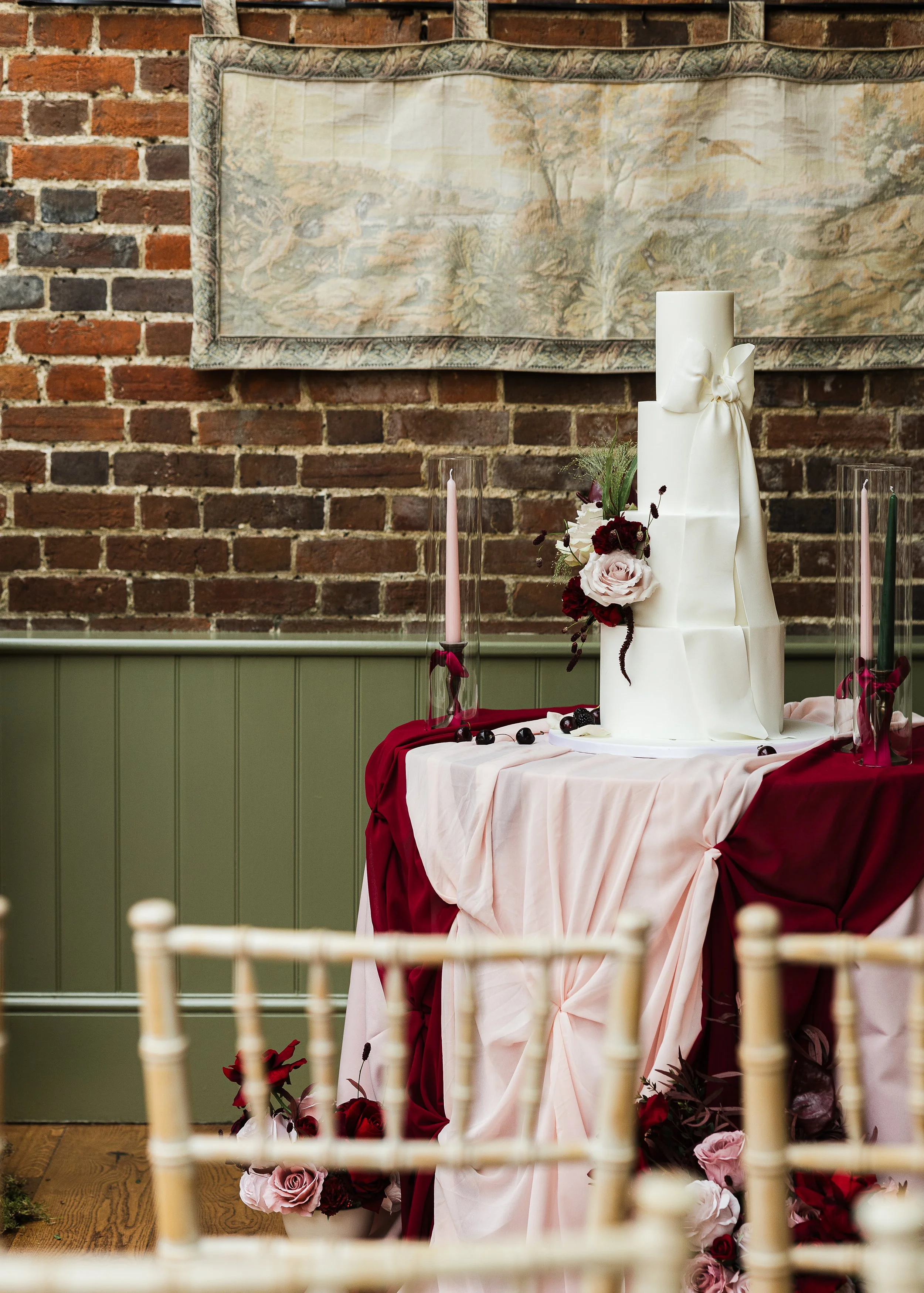 A beautiful 3 tier wedding cake with bow detailing at Offley Place Hertordshire