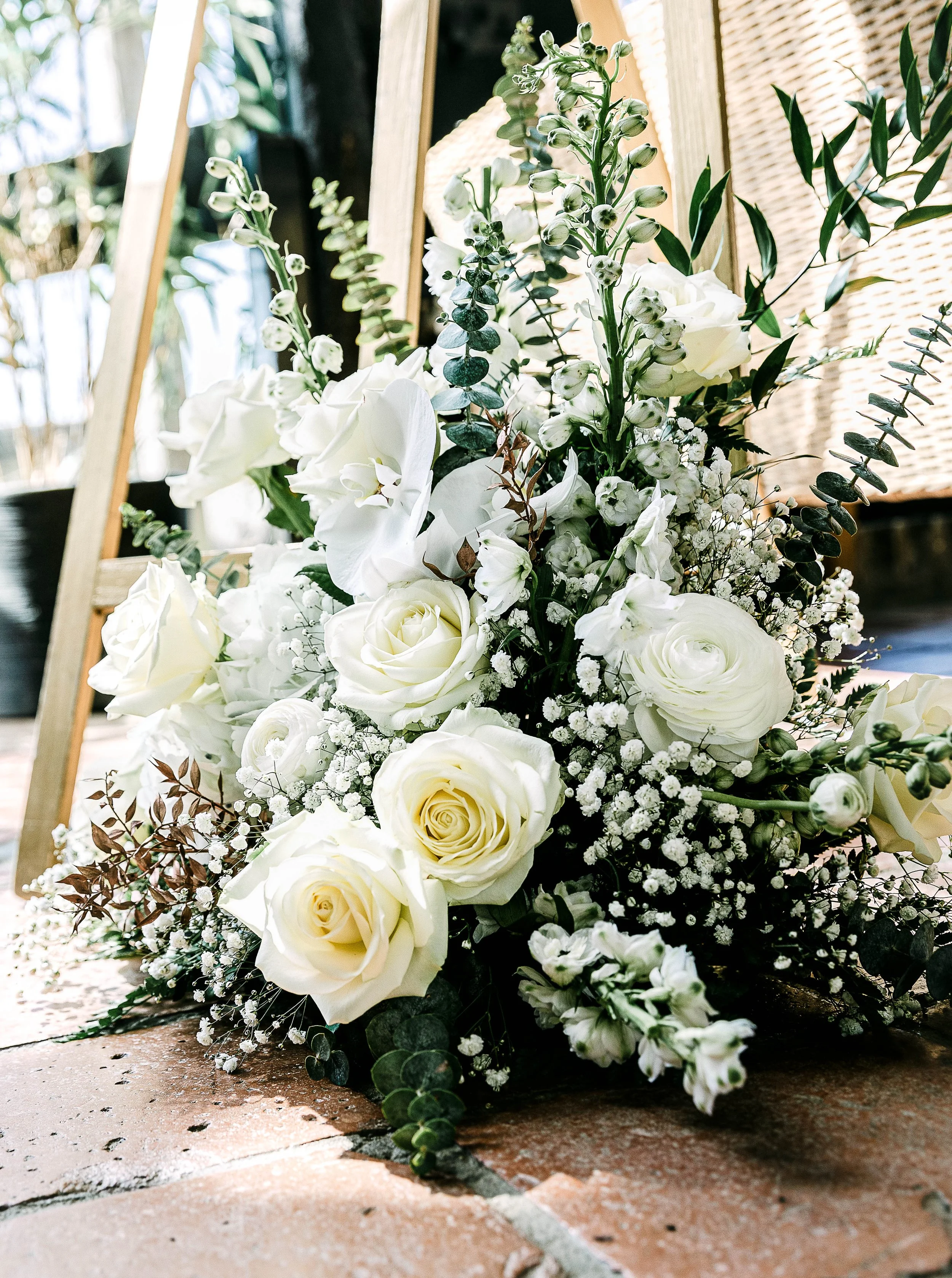 Stunning white rose floral arrangement at a wedding in South Farm Hertordshire