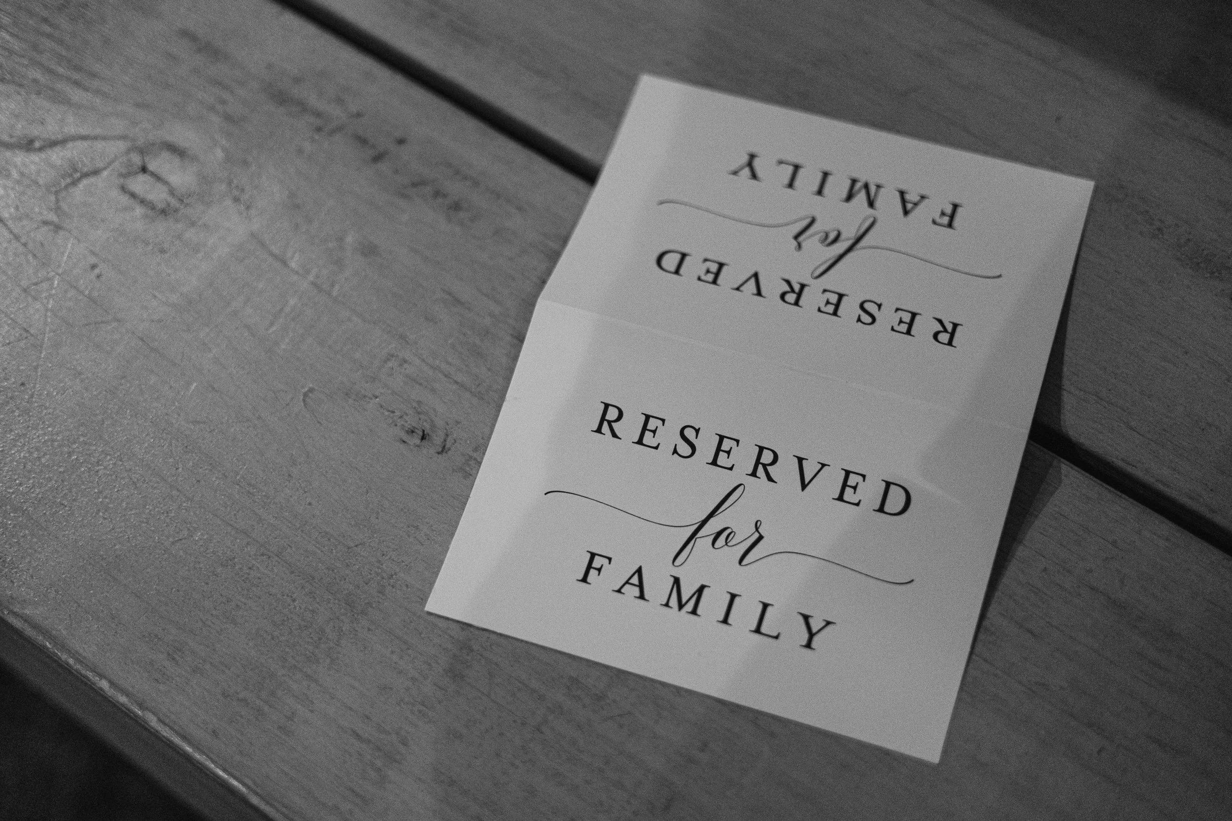 A "reserved for family" sign on a pew at Milling Barn Hertfordshire