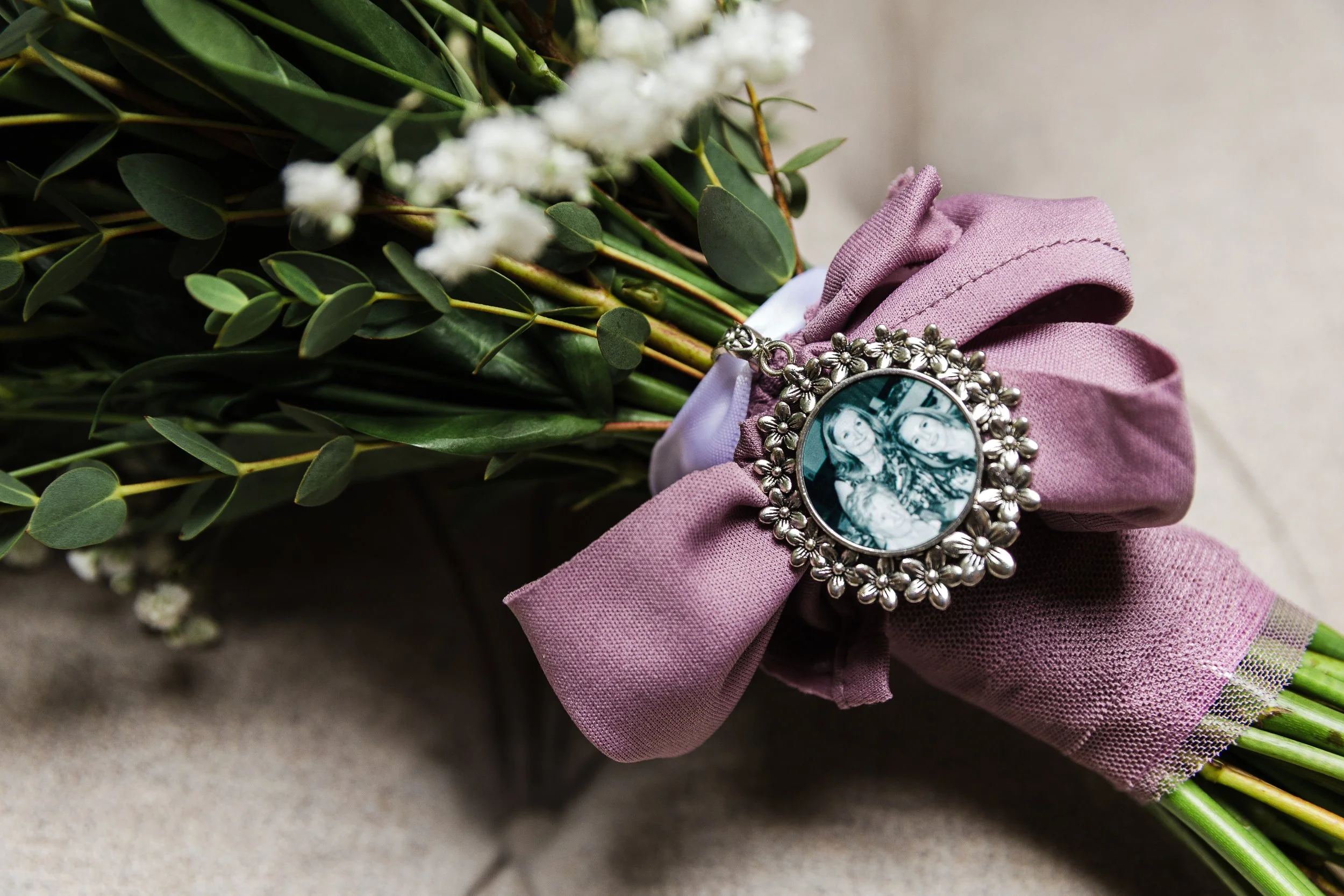 Fresh flower bridal bouquet with a bouquet charm in situ