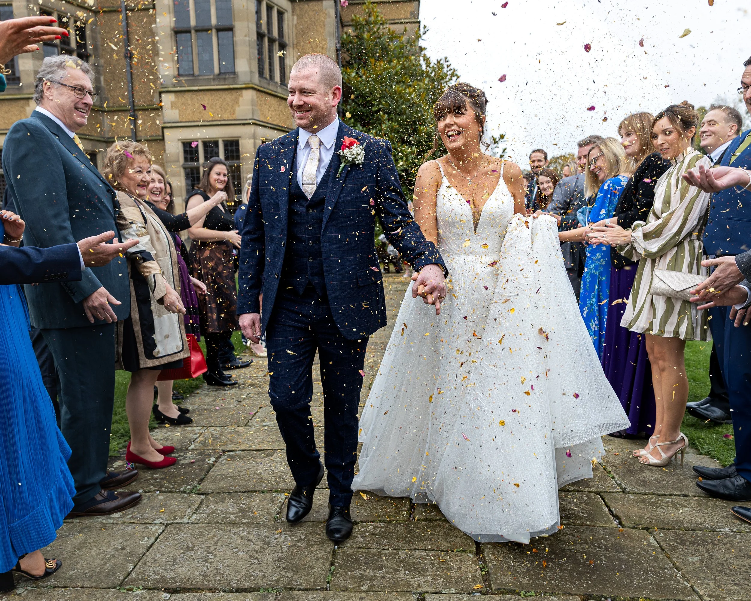 Bride and Groom during their confetti walk at Fanhams Hall Hertfordshire