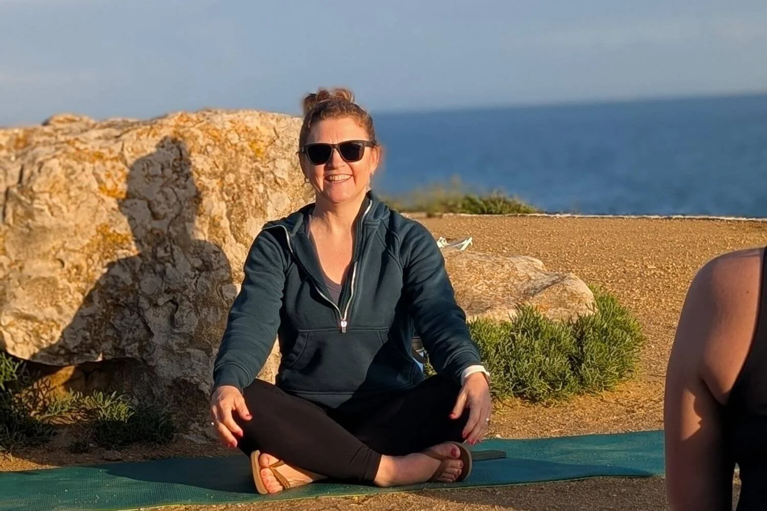 5:51 PMClaude responded: Dr.Dr. Trish Corley on the beach in Estoril practicing vinyasa yoga