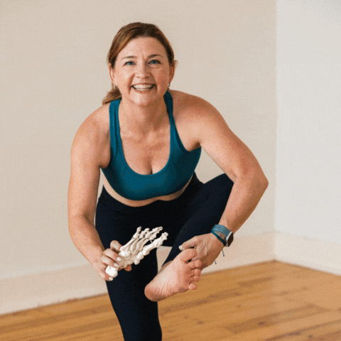 Dr Trish Corley teaching yoga and anatomy and practicing twisting triangle
