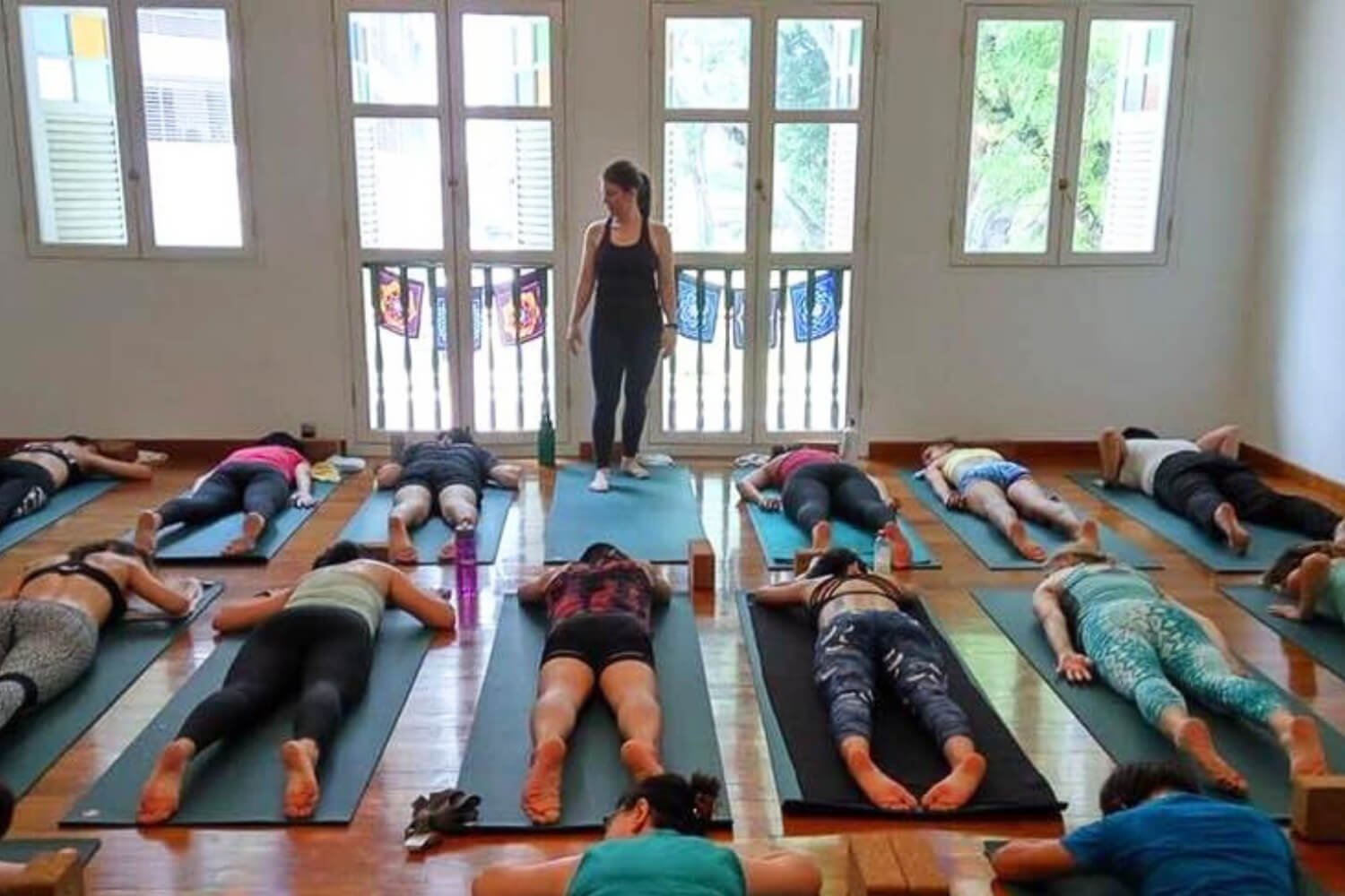 Trish observing and cueing yoga students during a yoga teacher training
