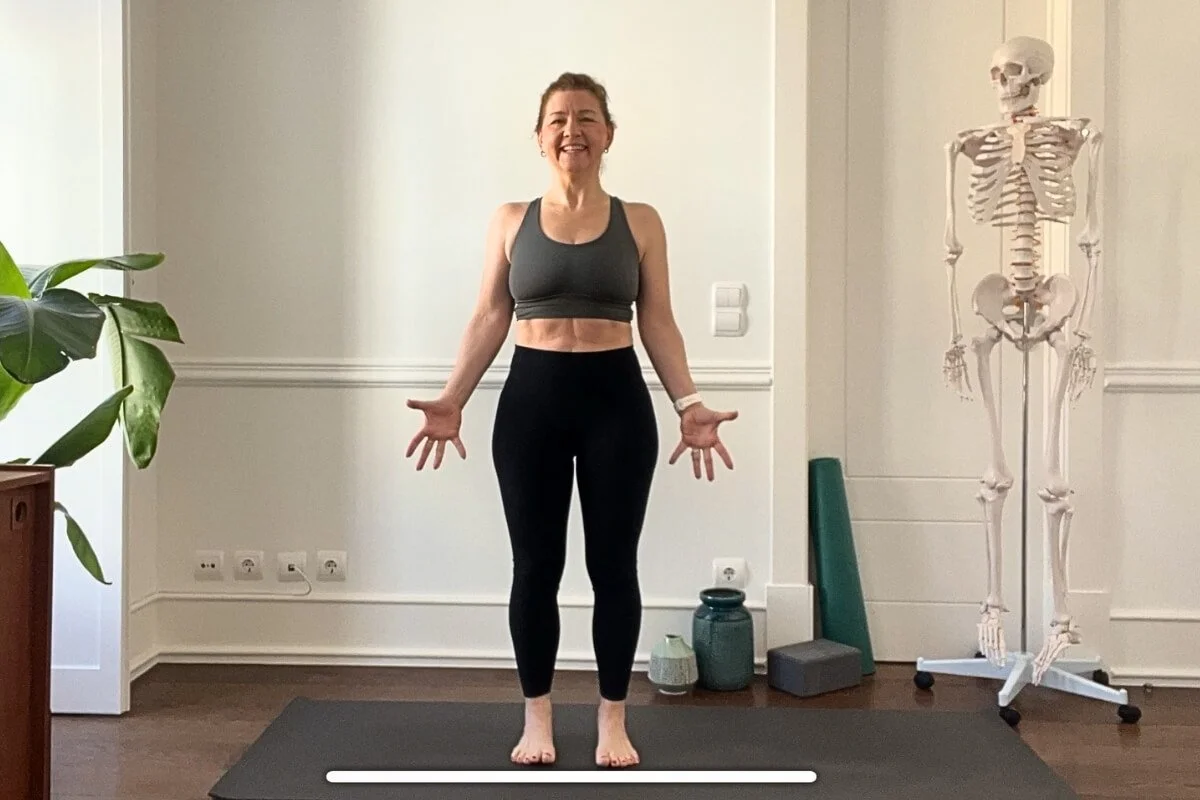 Trish Corley standing in Tadasana demonstrating foundational yoga alignment