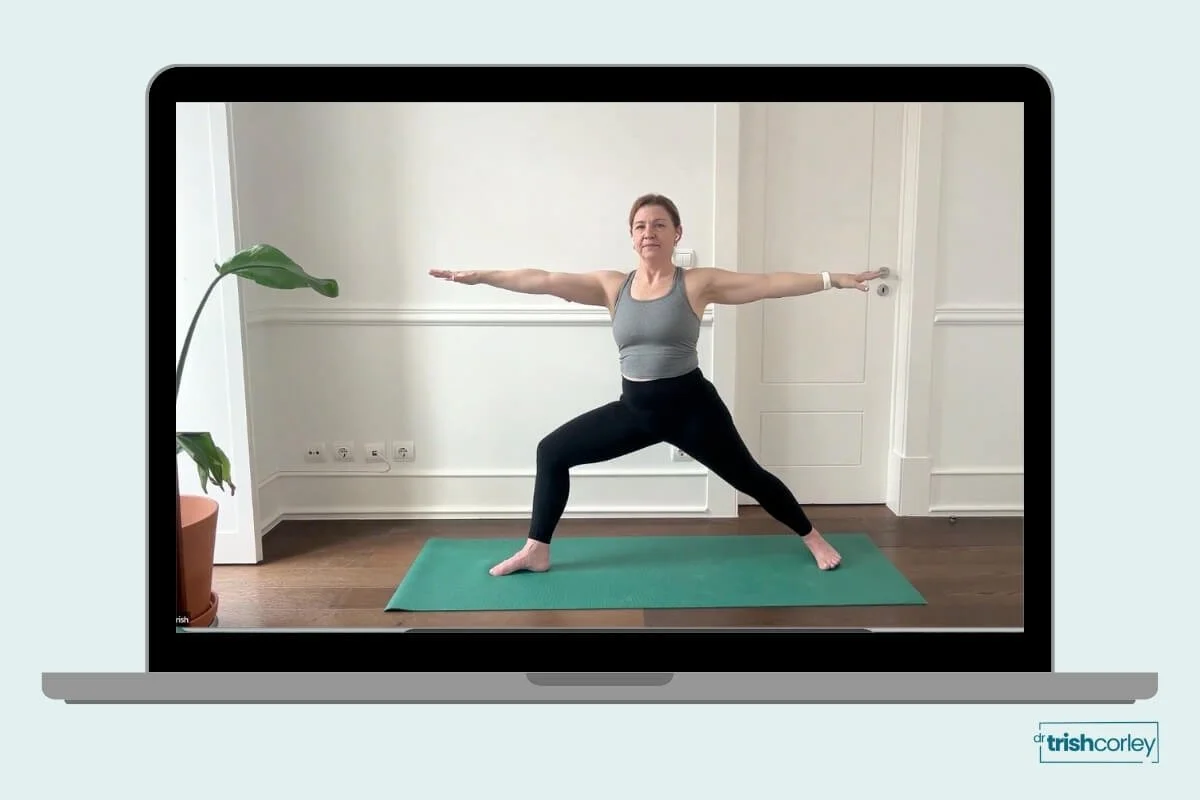 Yoga teacher cueing students in Warrior II, demonstrating principle-based yoga teaching