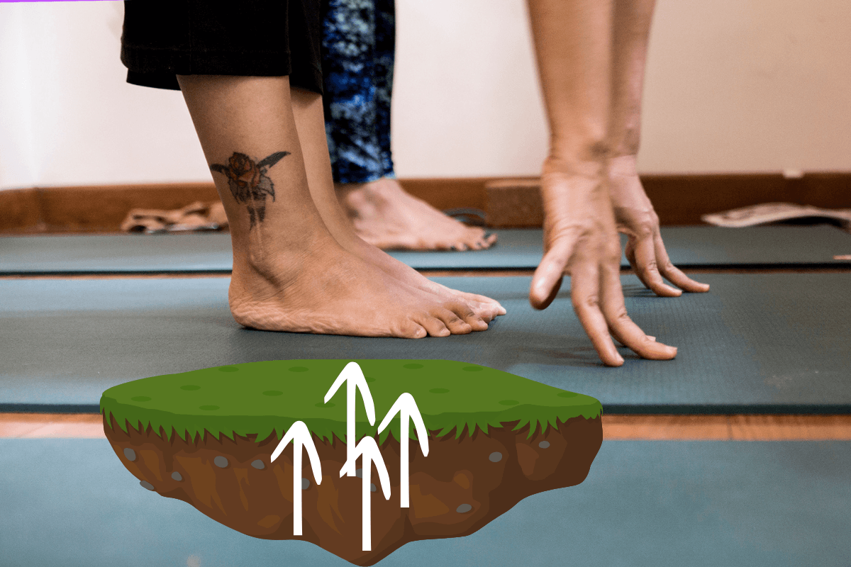 Yoga teacher's feet pressing into the mat, demonstrating yoga foundation cues for grounding